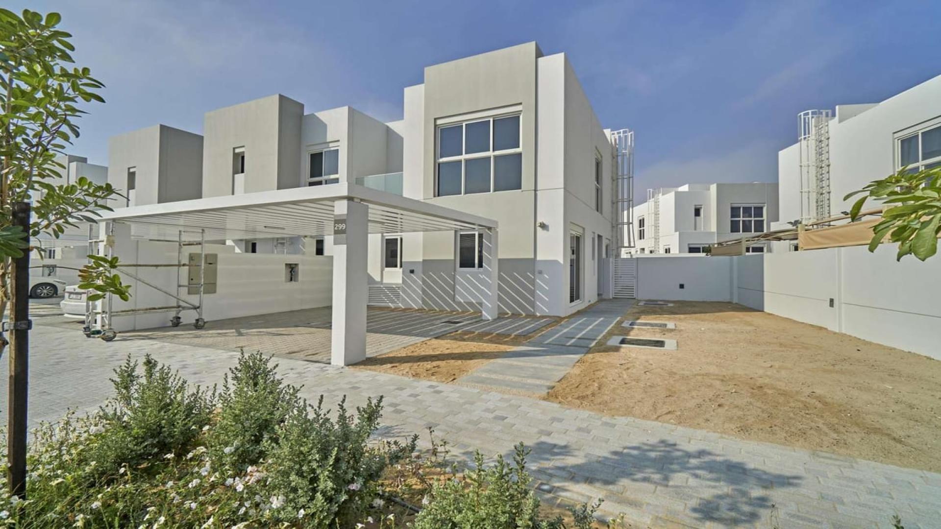 Spacious 4-bedroom townhouse exterior in Arabella 3, Mudon, with garden and carport