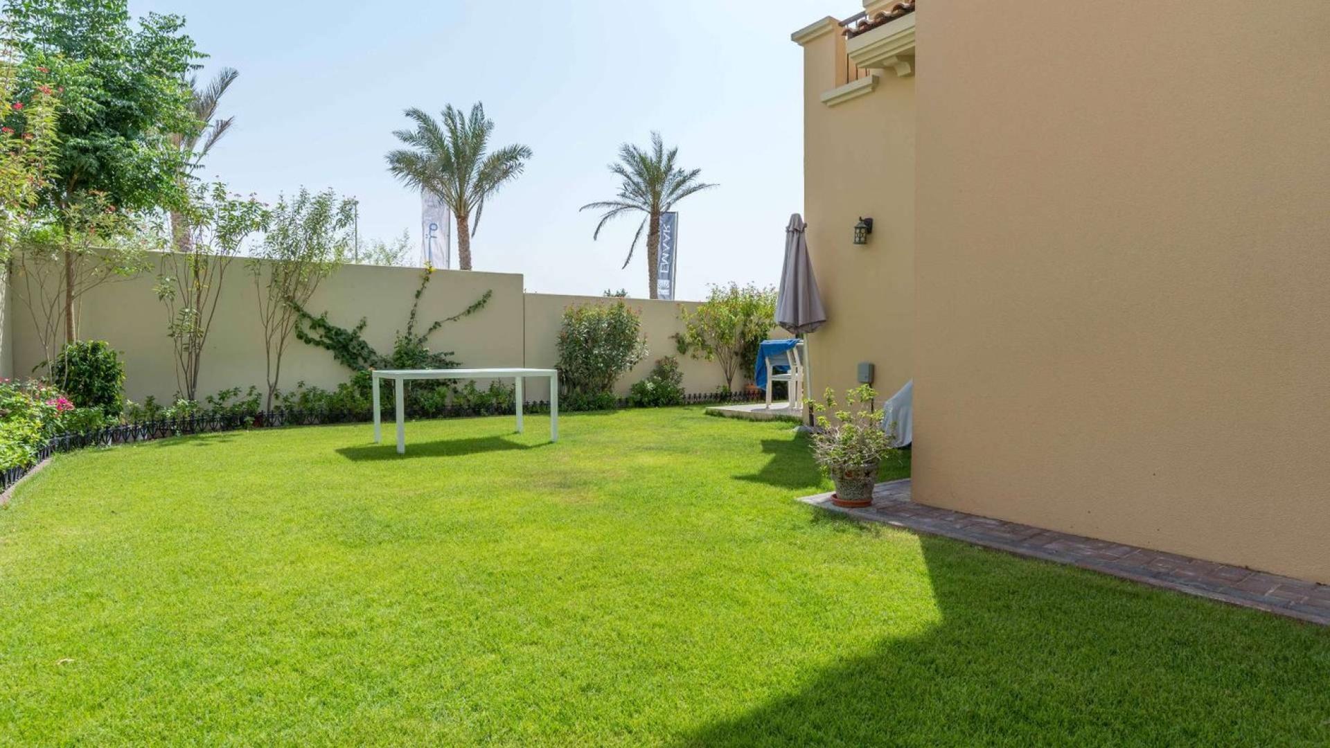 Outdoor pool area in Reem Mira townhouse community, Dubai, surrounded by lush greenery