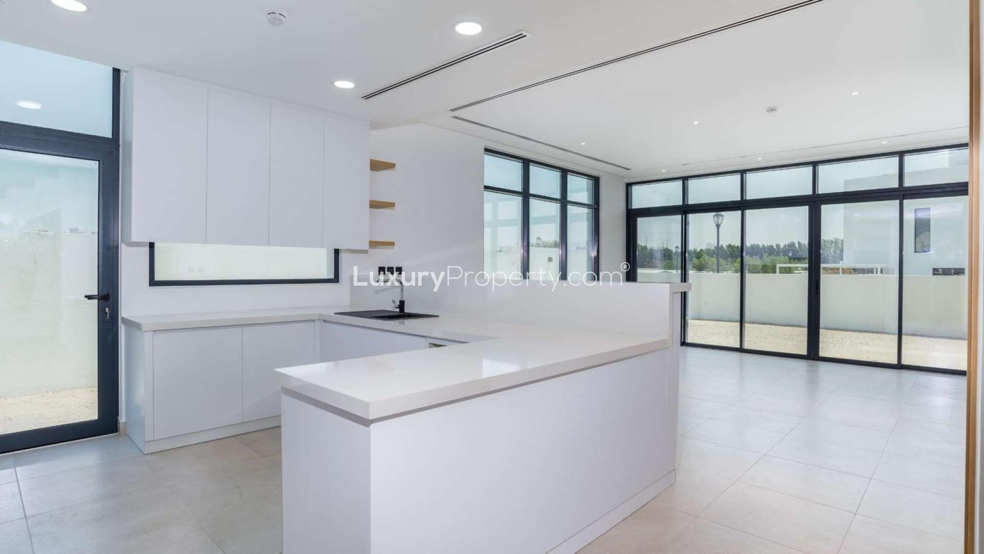 Modern kitchen and living area in Jumeirah Golf Estates townhouse for rent