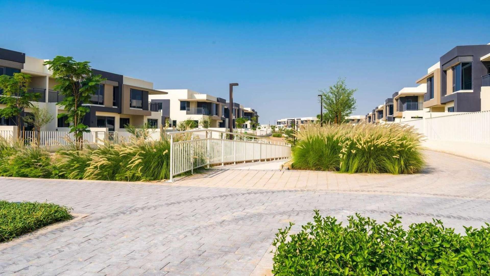 Lovely townhouse exterior in Maple, Dubai Hills Estate, featuring lush green surroundings