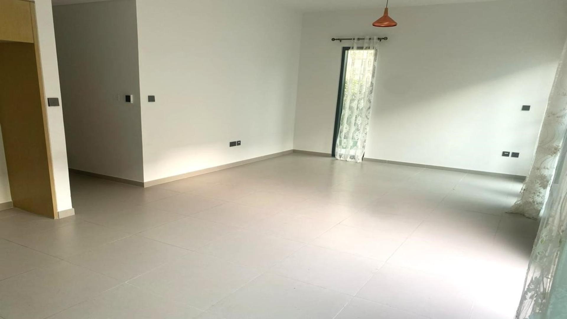 Modern kitchen and living area in Arabian Ranches 3 townhouse, corner plot, vacant, for rent