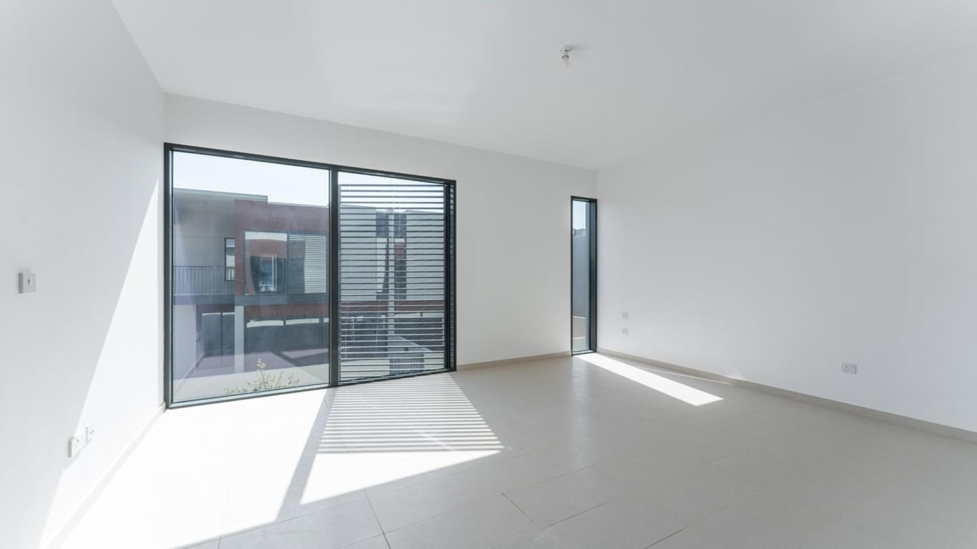 Spacious living room with large windows in Cherrywoods townhouse, Dubai Land for rent