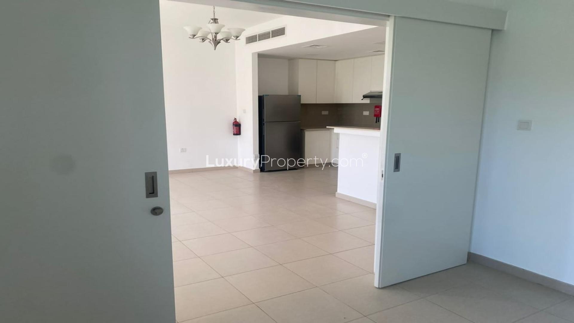 Spacious living room in Noor Townhouses, Town Square, with garden view and natural light