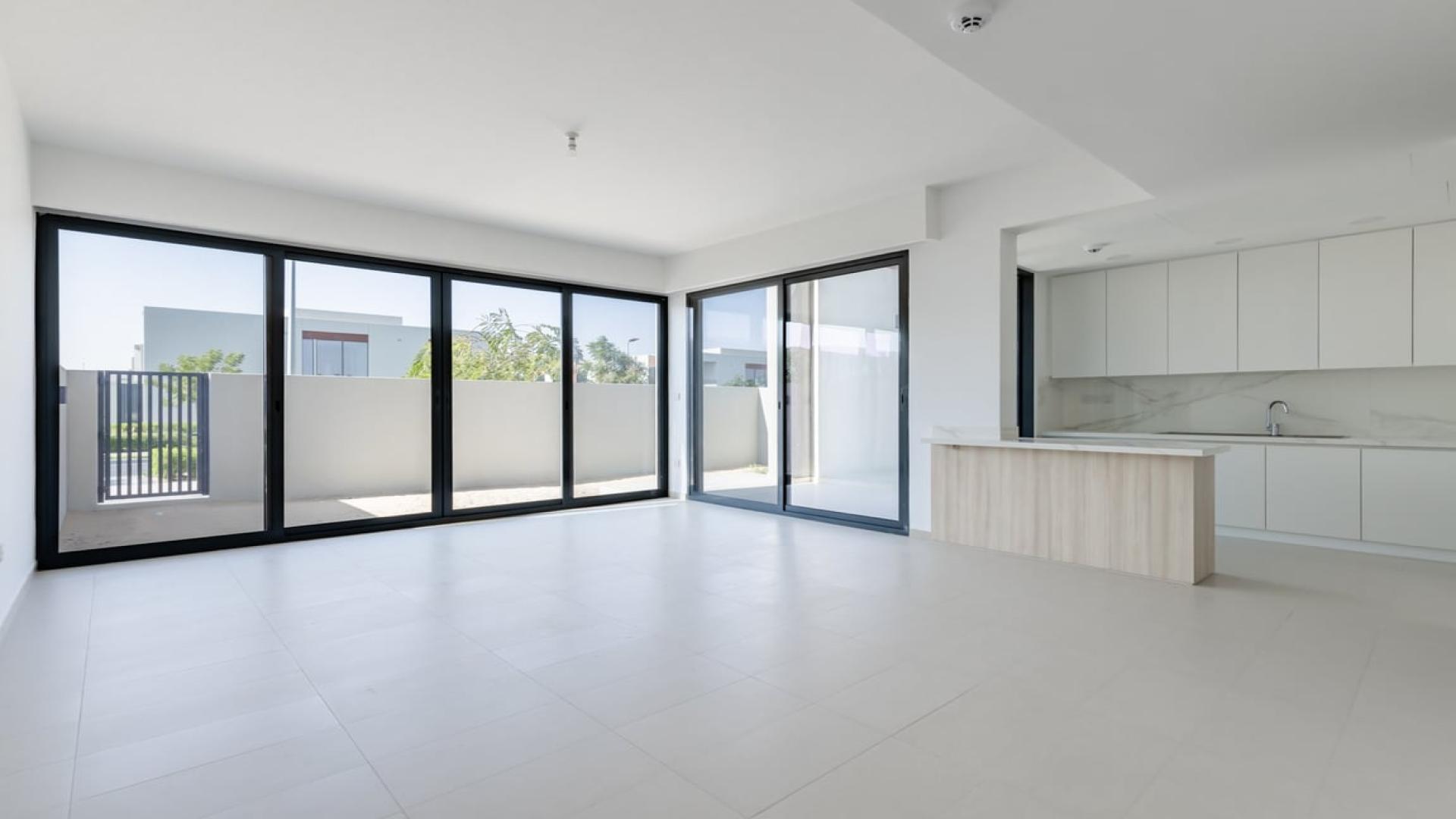 Modern open-plan kitchen and living area in Cherrywoods townhouse, Dubai Land