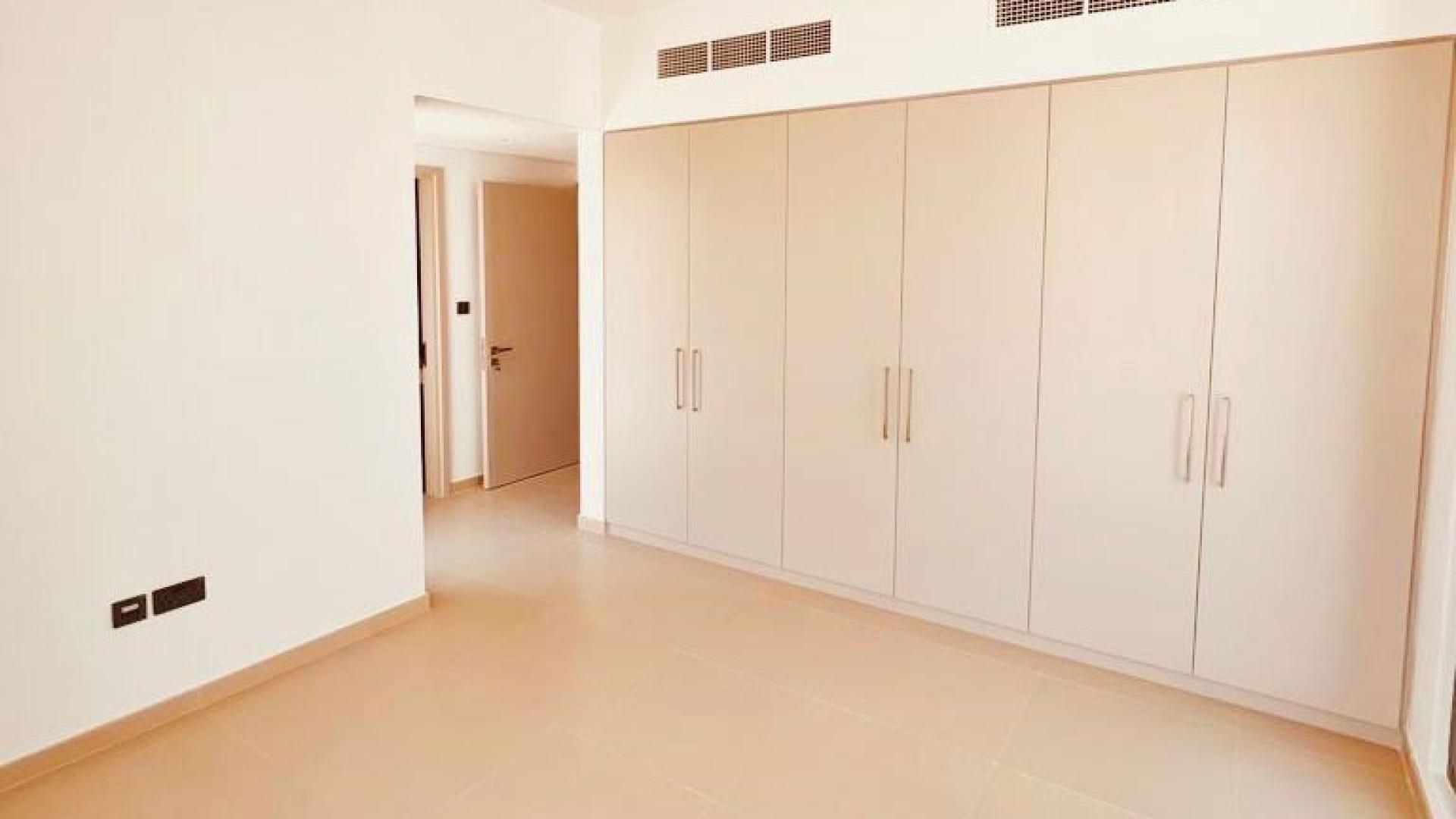 "Modern kitchen and hallway in 4-bedroom townhouse, Spring Arabian Ranches 3 for rent.",Newly built townhouse bedroom with built-in wardrobes in Spring, Arabian Ranches 3