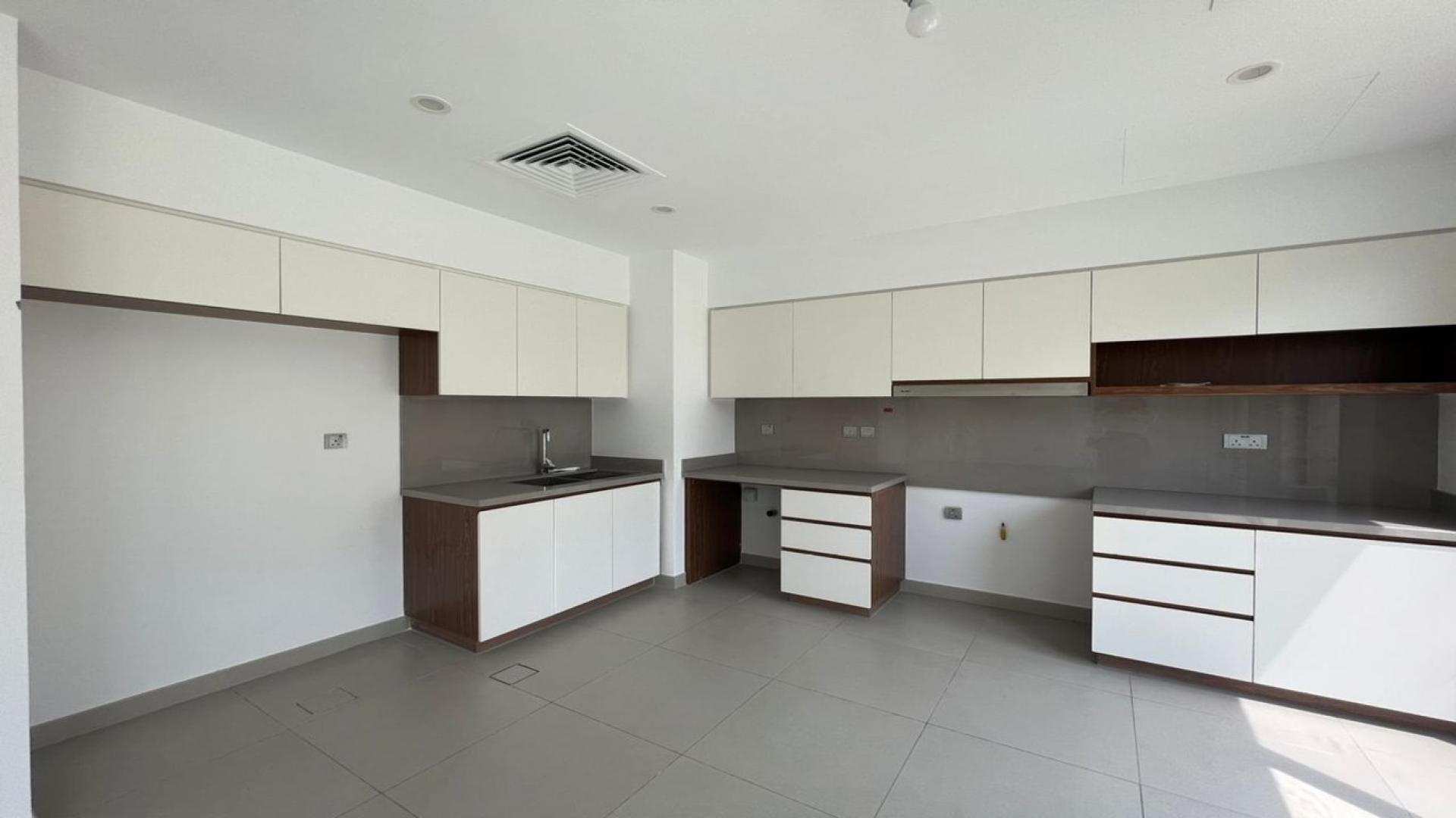 Bright living area in spacious Camelia townhouse, Arabian Ranches 2, with large windows and garden view