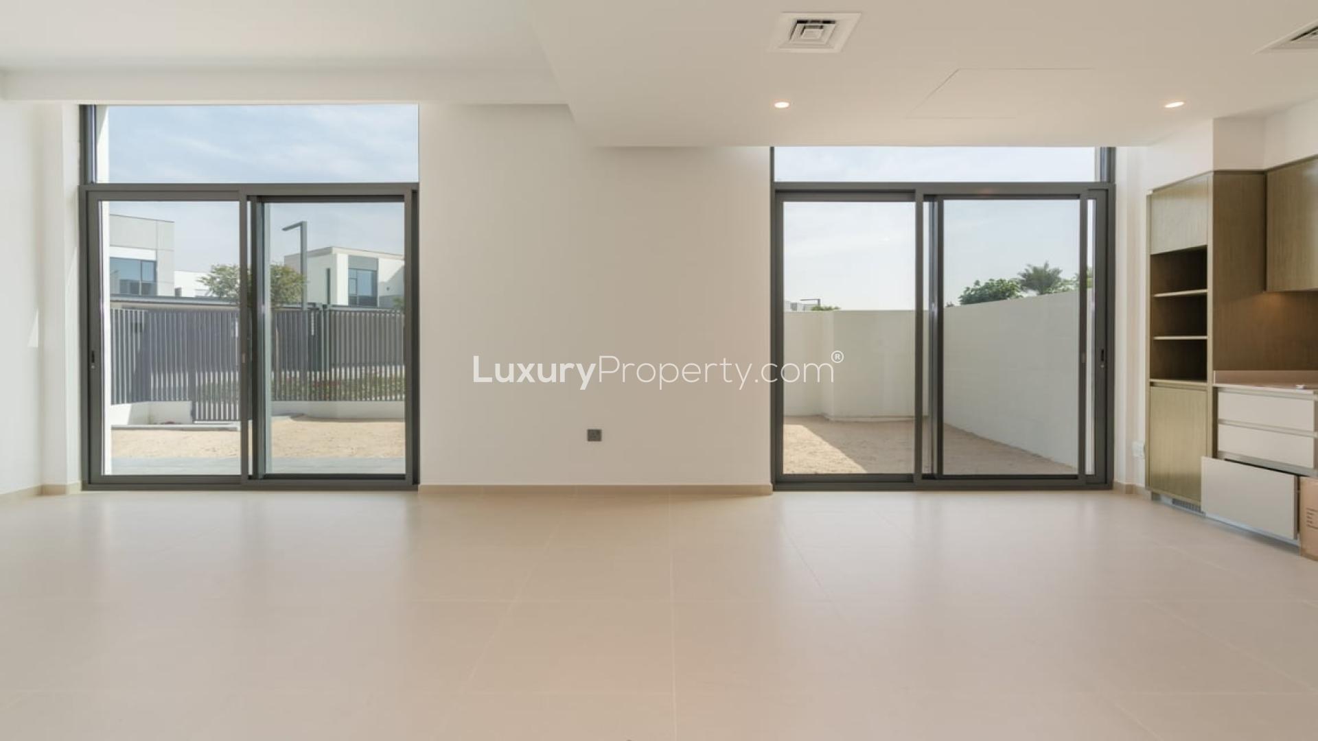 "Modern 4-bedroom villa exterior in Sun, Arabian Ranches 3, Dubai for rent.",Modern living room with large windows in 4-bedroom villa, Sun, Arabian Ranches 3, Dubai