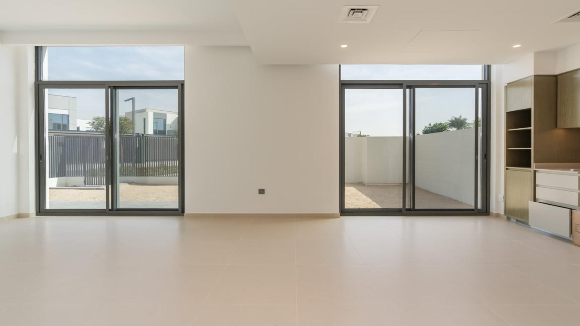"Modern 4-bedroom villa exterior in Sun, Arabian Ranches 3, Dubai for rent.",Modern living room with large windows in 4-bedroom villa, Sun, Arabian Ranches 3, Dubai