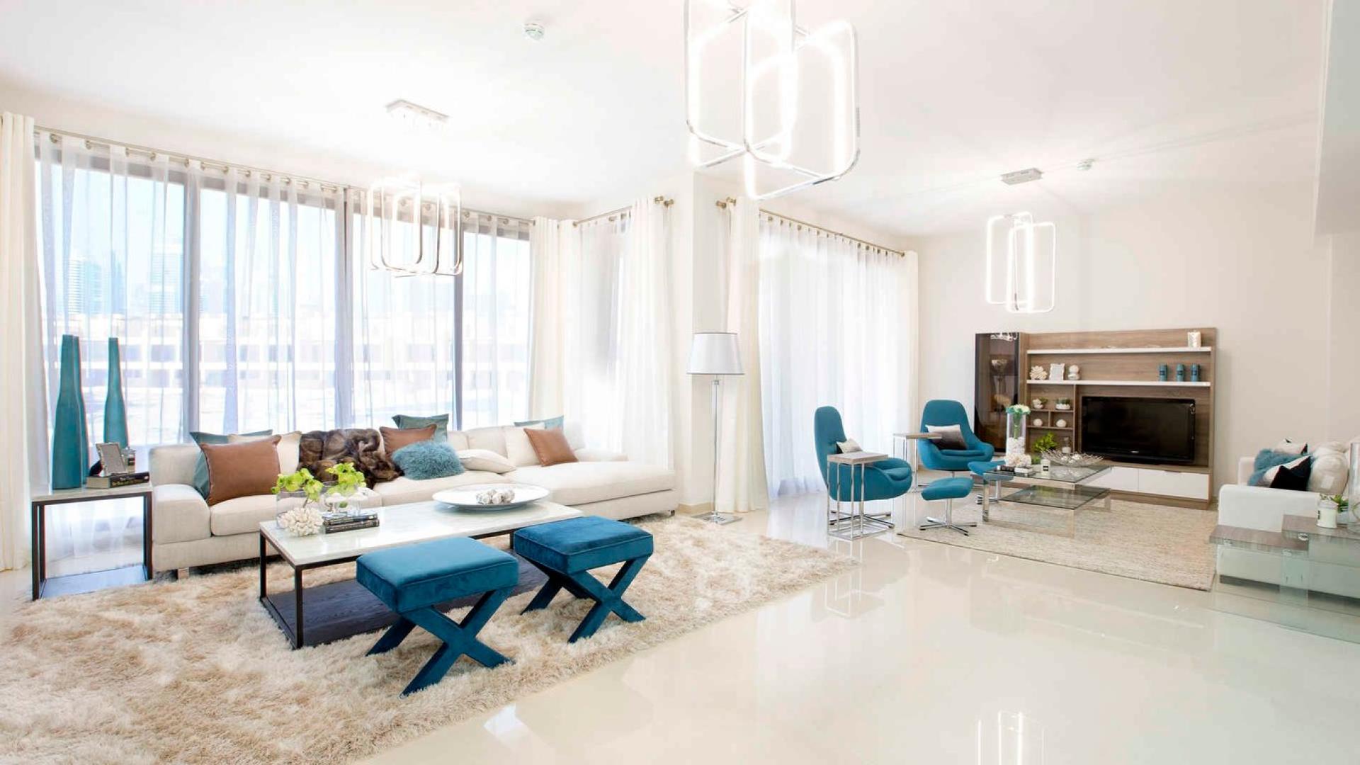 Modern living room in Jumeirah Islands townhouse, Dubai with elegant furnishings and natural light