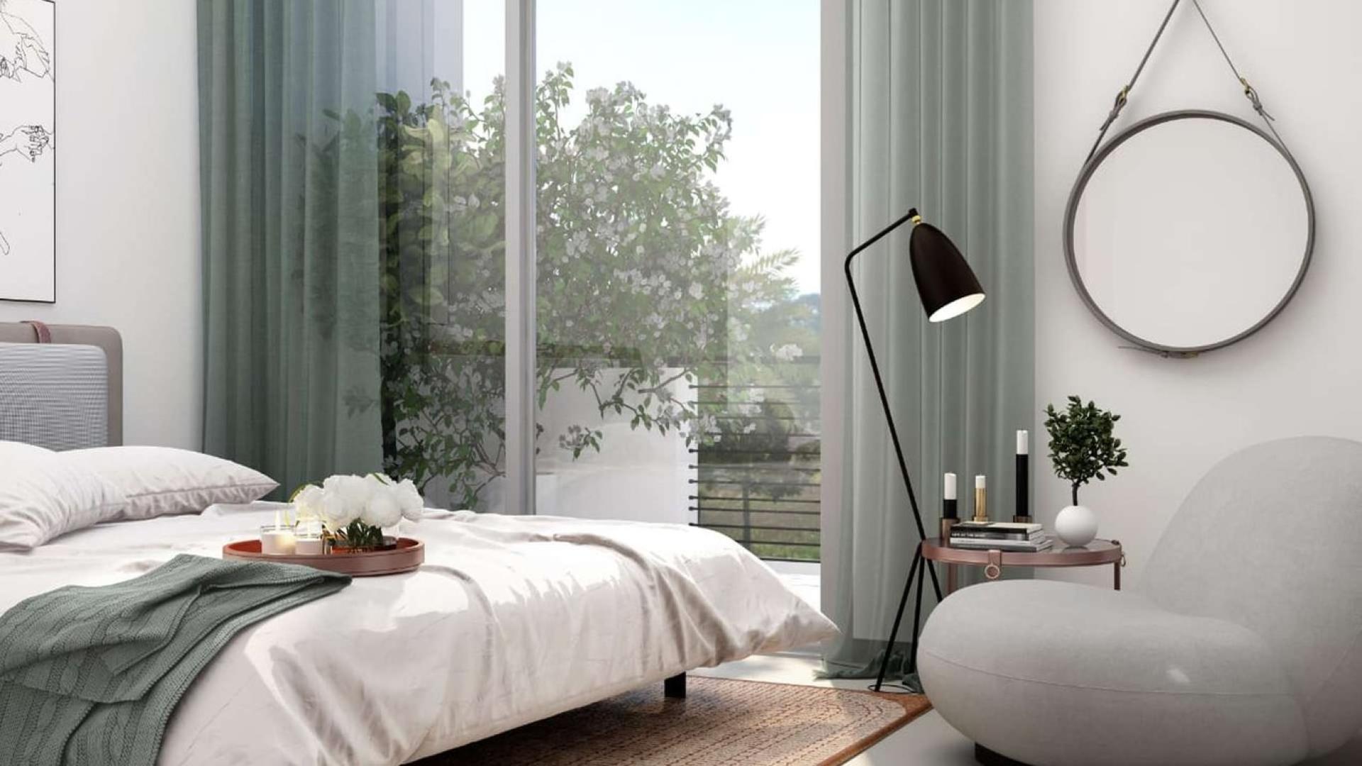 Cozy bedroom in four-bedroom townhouse, Arabian Ranches III, with modern decor and garden view