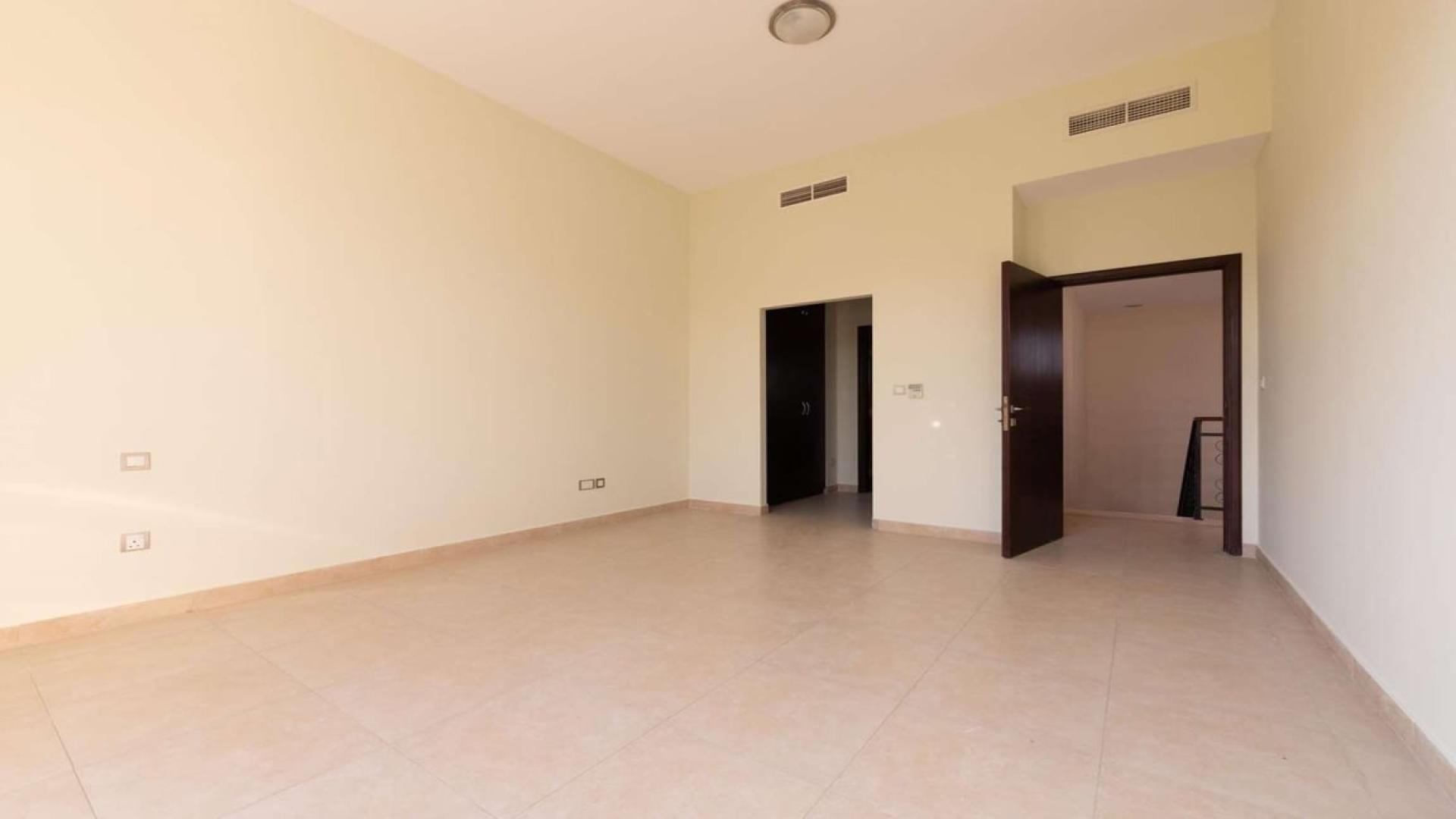 Bright bedroom in Naseem townhouse, Mudon with large windows and built-in wardrobe