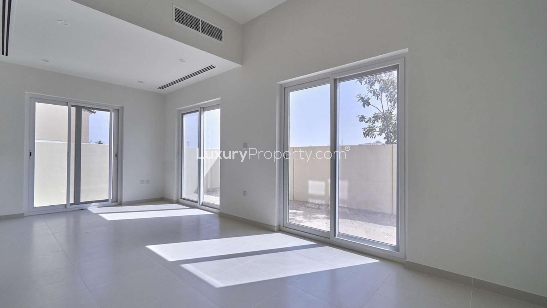 Single row corner townhouse in Villanova, Dubai Land, featuring spacious driveway and modern design