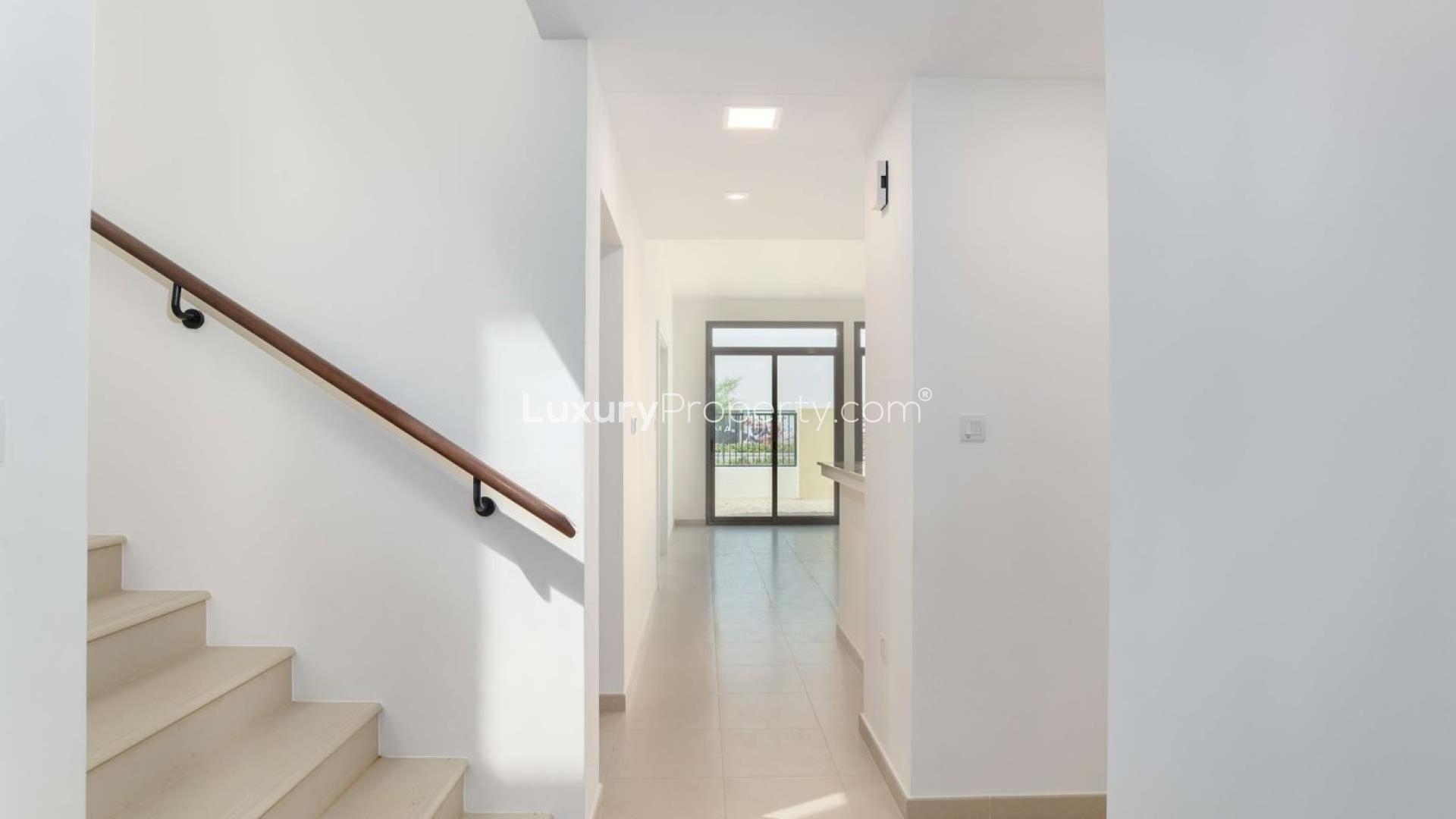 Four-bedroom townhouse exterior in Naseem Townhouses, Town Square Dubai, surrounded by lush greenery