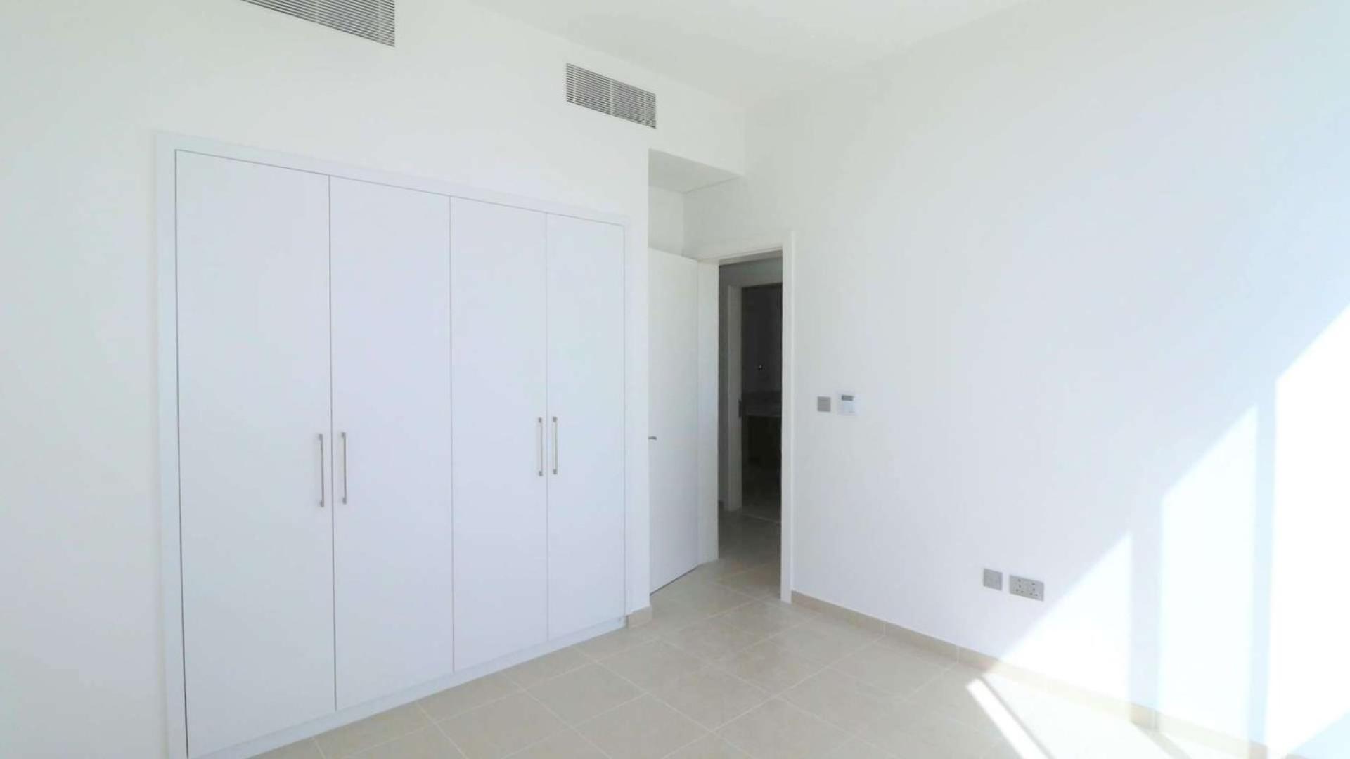 Bright bedroom with built-in wardrobe in Arabian Ranches 2 townhouse for sale