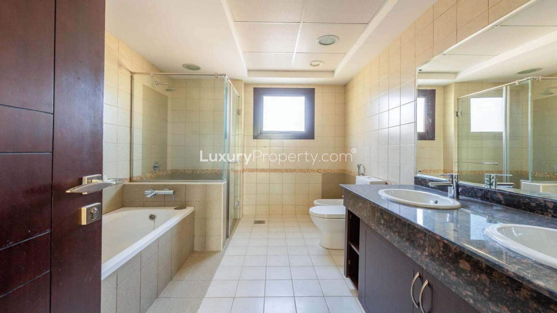 Spacious backyard with lush lawn in Al Salam townhouse, Mudon Community, for sale