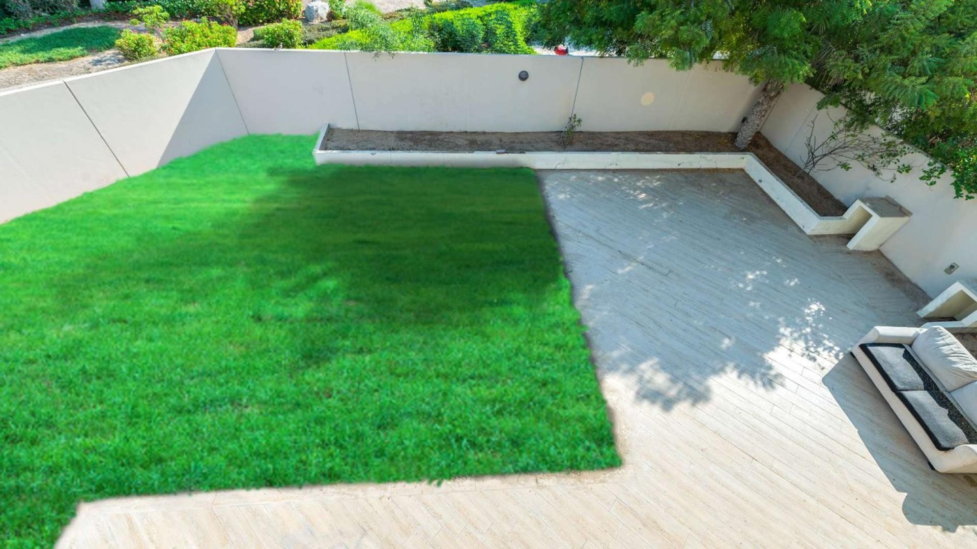 "Elegant 4-bedroom townhouse exterior with lush garden in Al Salam, Mudon Community for sale.",Spacious backyard with lush lawn in Al Salam townhouse, Mudon Community