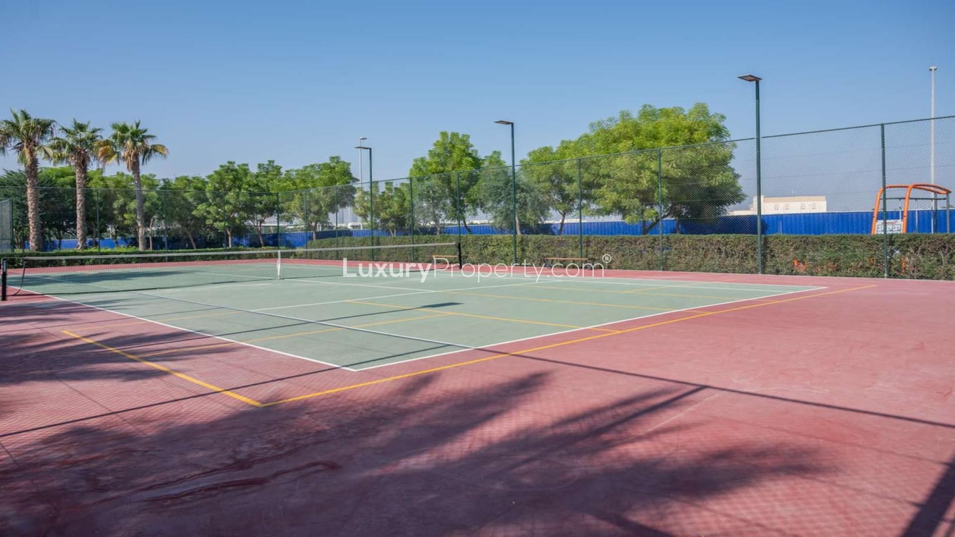 Spacious townhouse street view in Al Salam, Mudon, Dubai with lush greenery and pathways