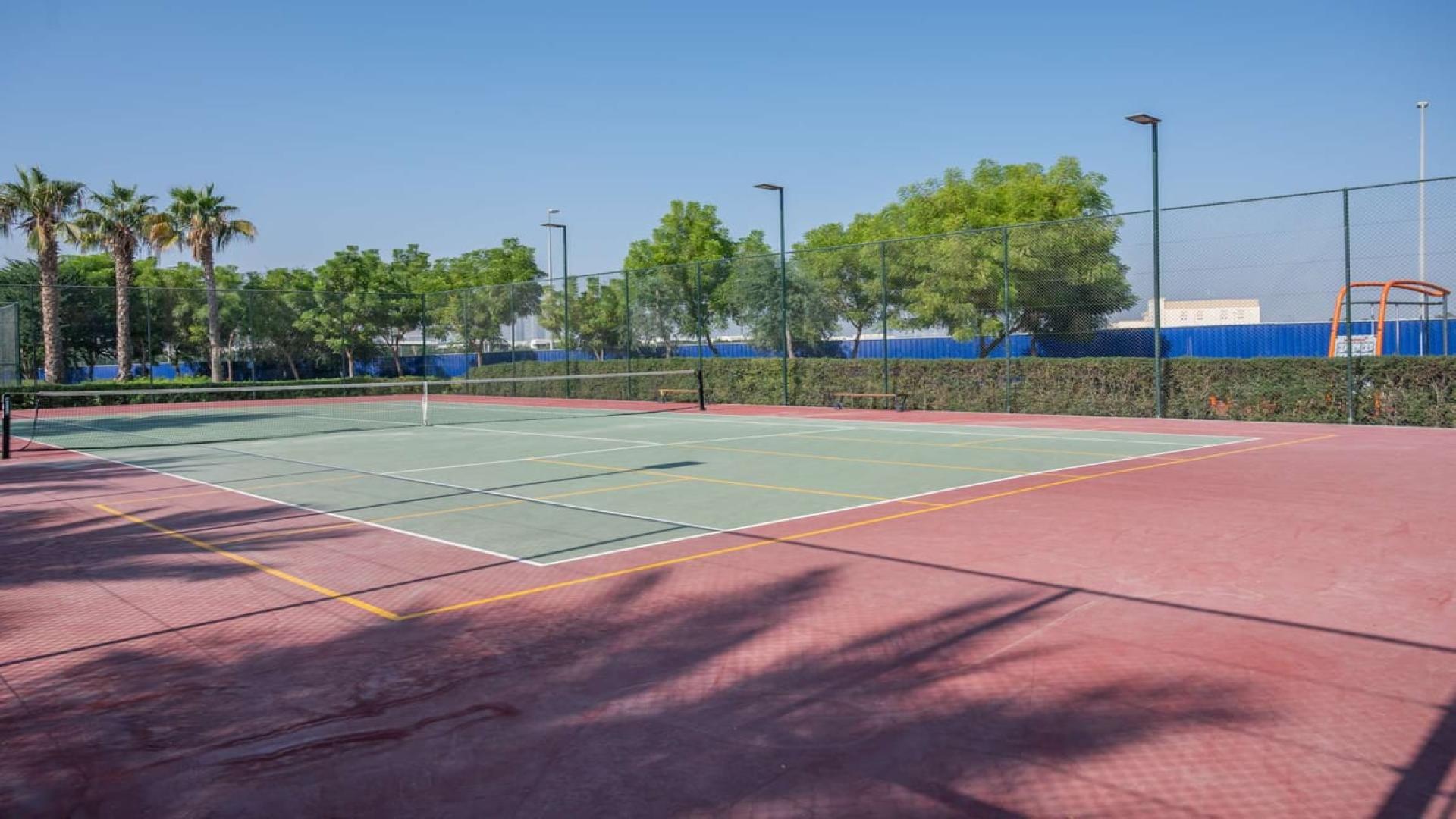 Spacious townhouse street view in Al Salam, Mudon, Dubai with lush greenery and pathways