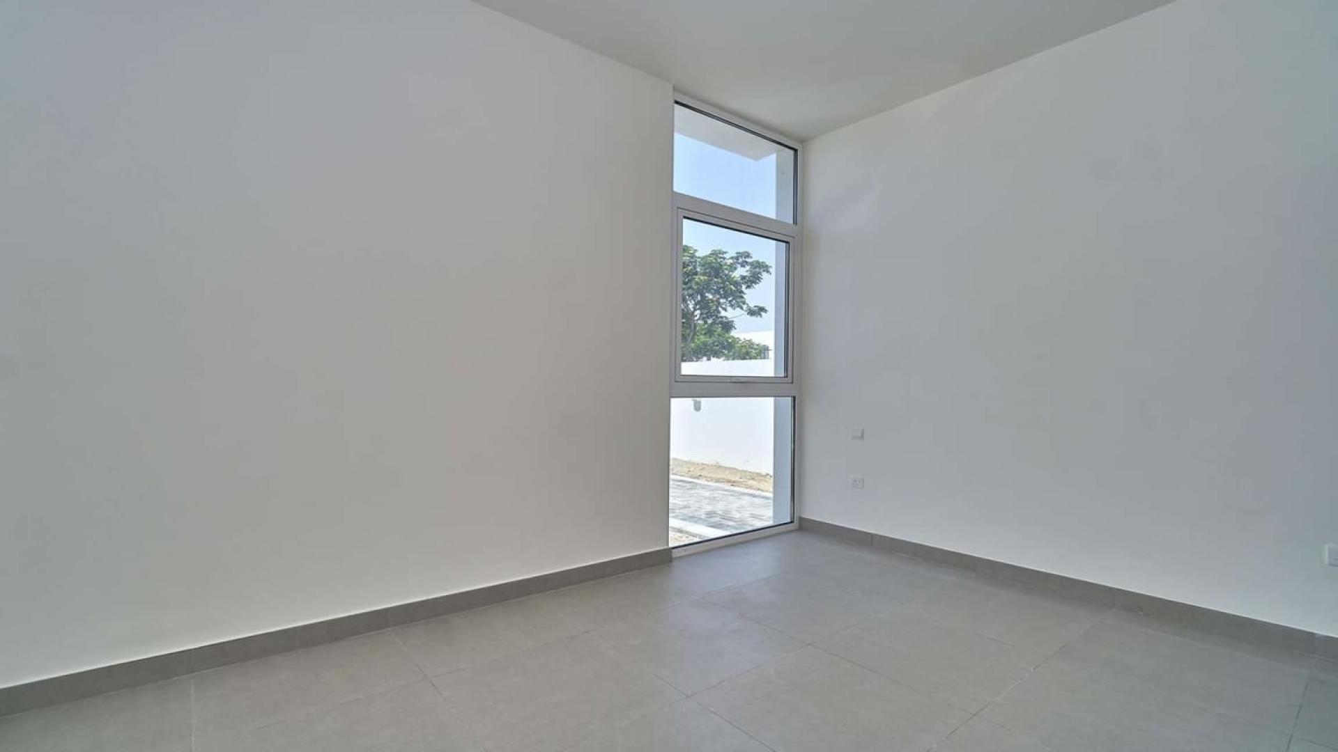 Four-bedroom townhouse exterior with driveway in Arabella Townhouses, Mudon community, for sale