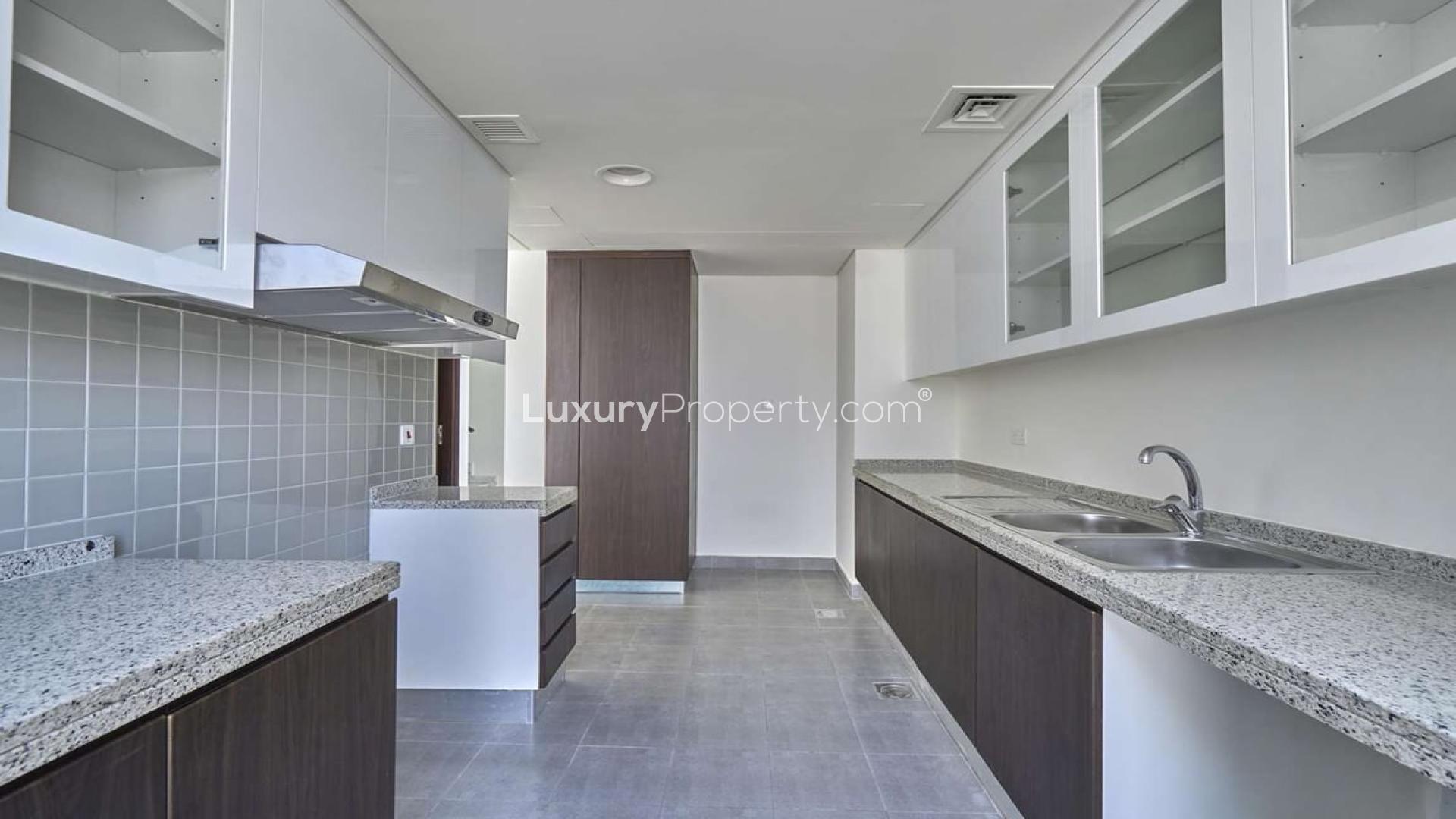 "Spacious living room in 4-bedroom duplex for sale, Arabella 1, Mudon townhouse.",Modern kitchen in 4-bedroom duplex, Arabella 1, Mudon townhouse for sale