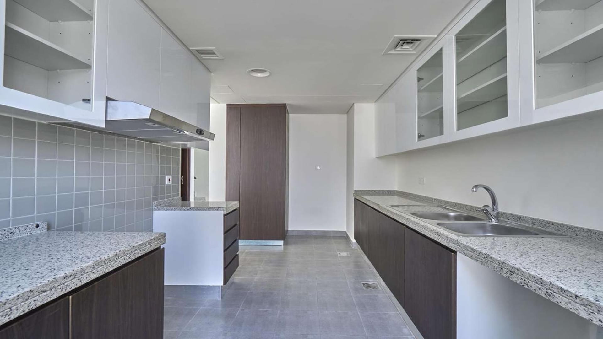 "Spacious living room in 4-bedroom duplex for sale, Arabella 1, Mudon townhouse.",Modern kitchen in 4-bedroom duplex, Arabella 1, Mudon townhouse for sale