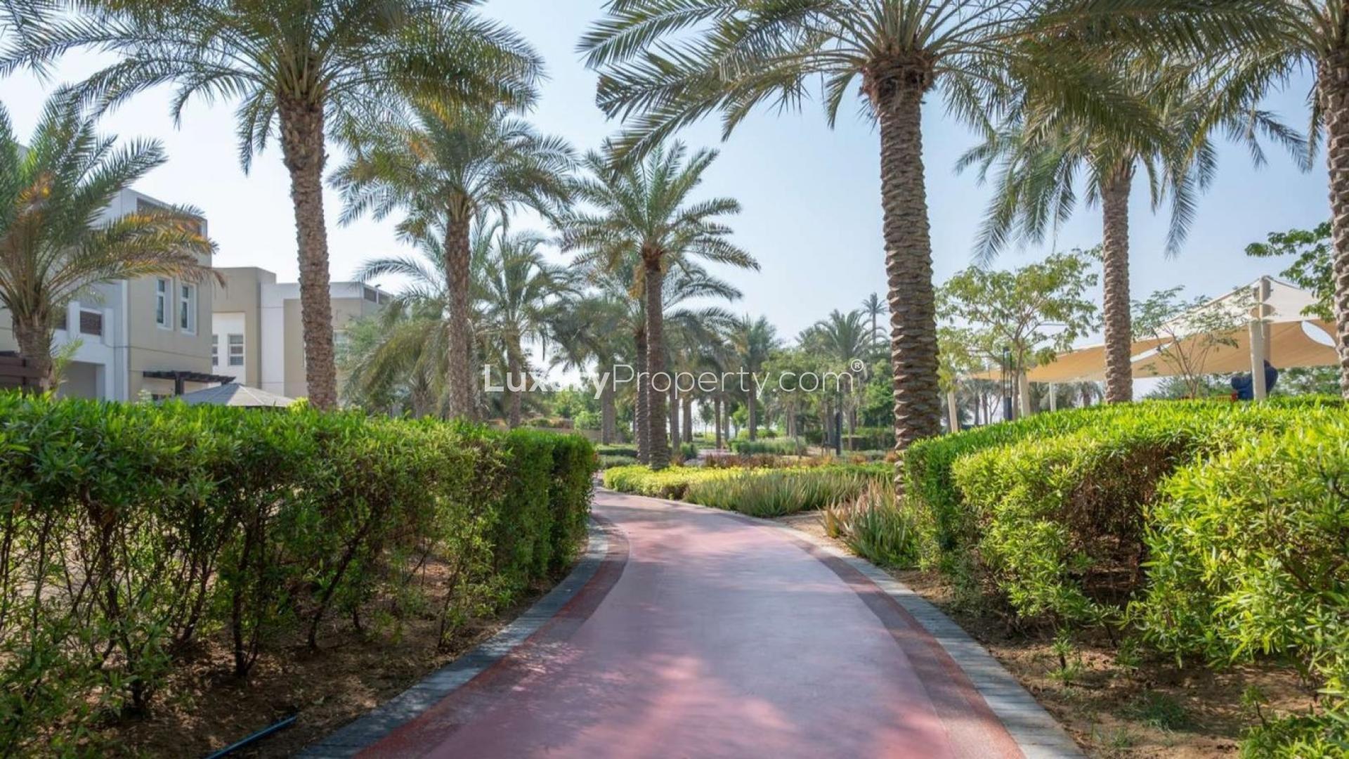 Beautiful landscaped path in Naseem, Mudon community near four-bedroom townhouse for sale