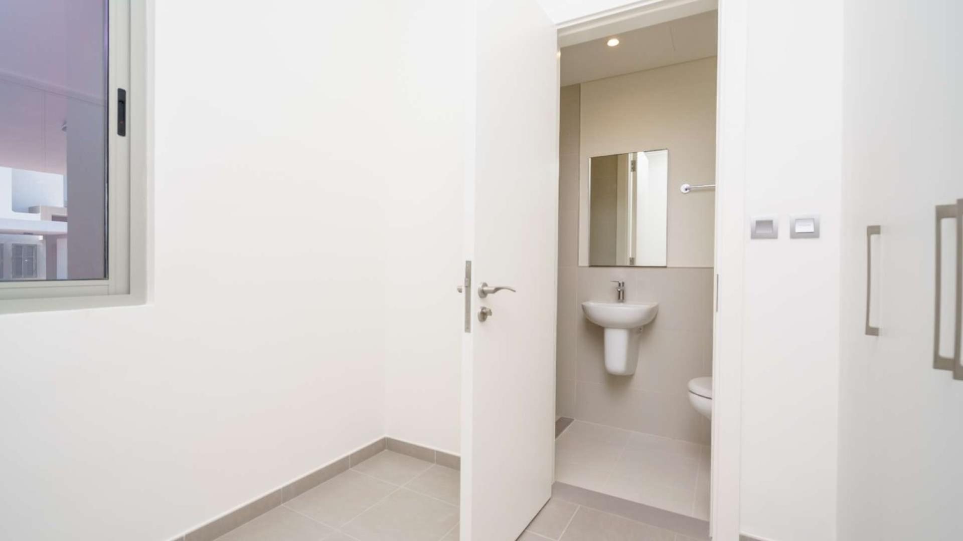 Modern bathroom in Arabian Ranches 2 townhouse, featuring sleek fixtures and neutral decor