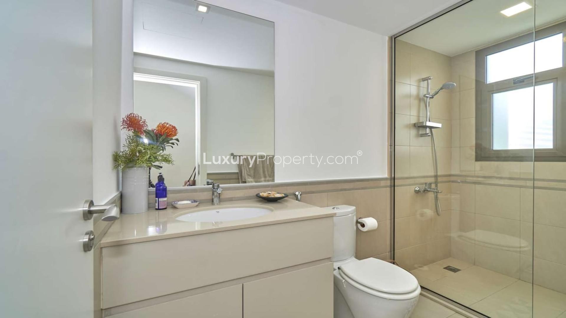 Stunning Hayat Townhouse garden with patio, palm trees, and outdoor seating in Town Square