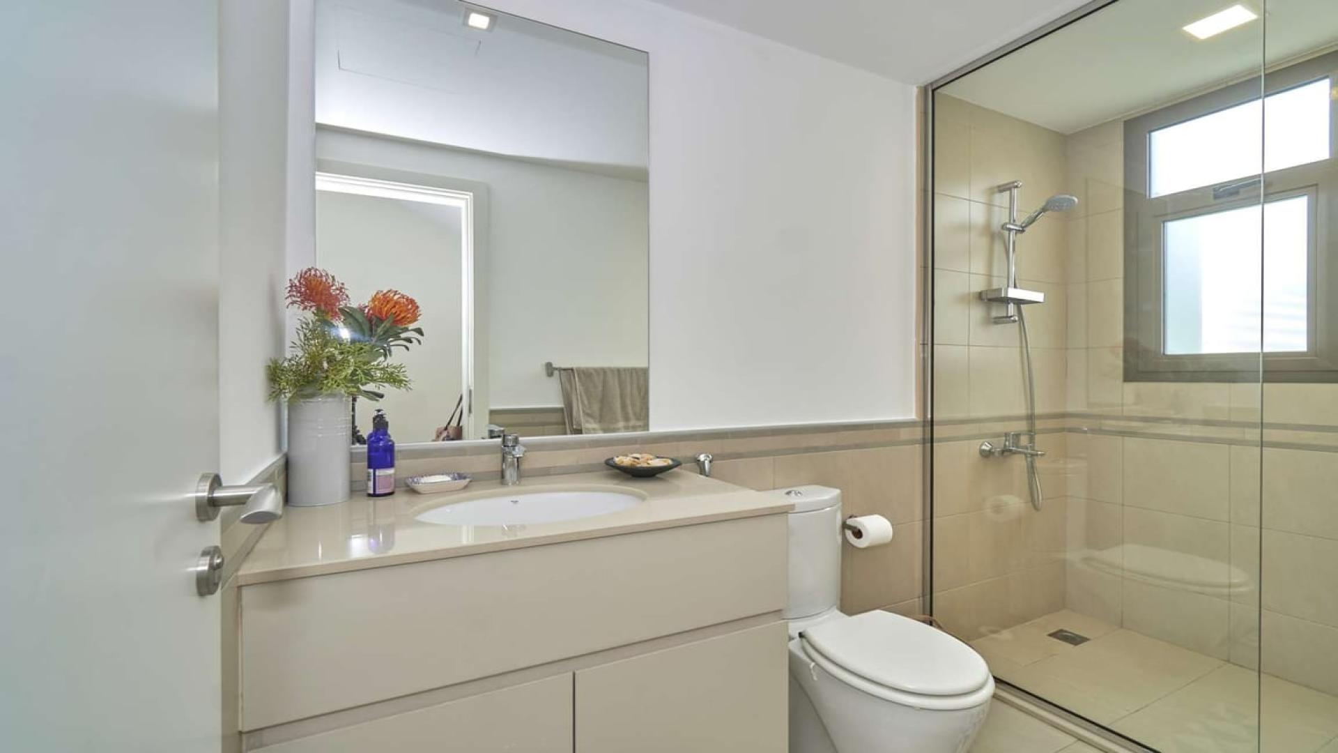 Stunning Hayat Townhouse garden with patio, palm trees, and outdoor seating in Town Square