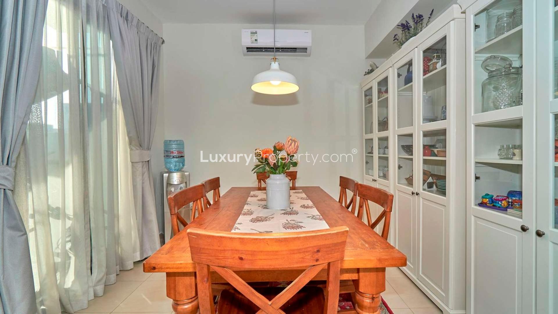 Stunning 4-bedroom corner townhouse exterior in Hayat, Town Square, with driveway and palm tree