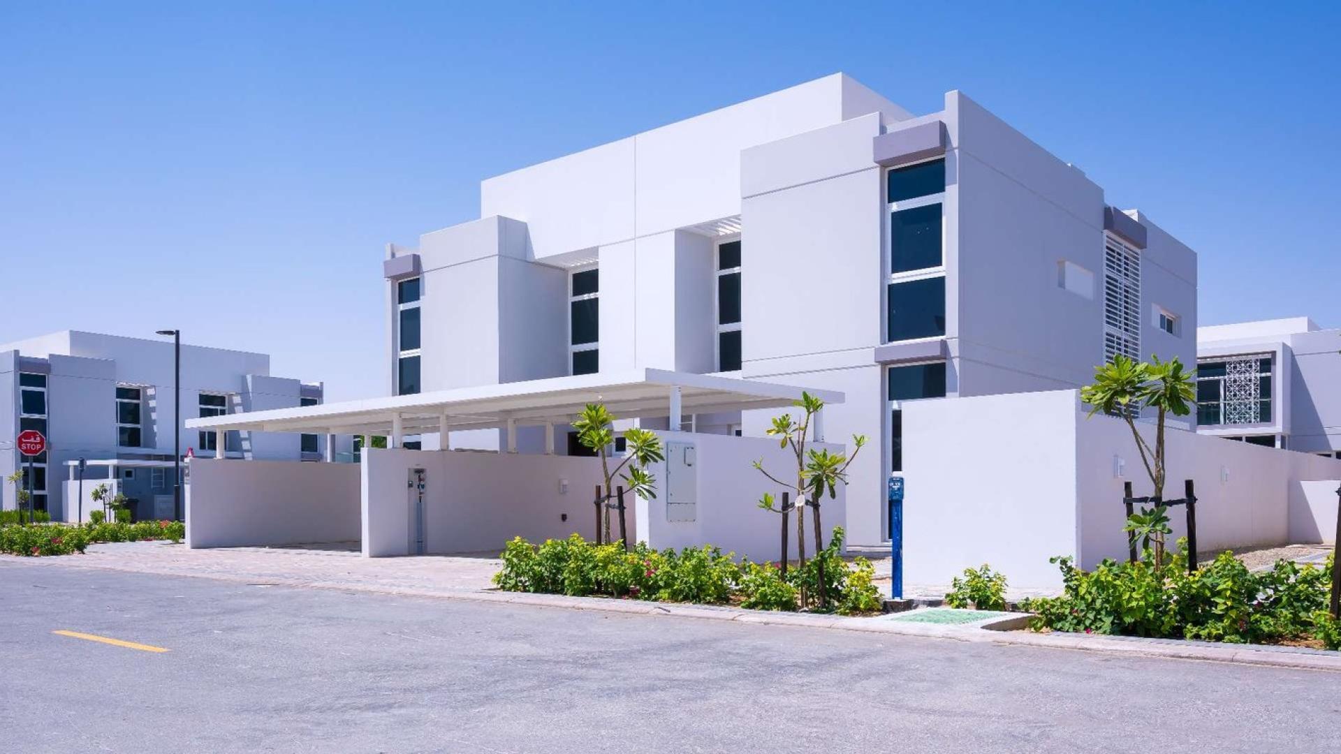 Spacious living room in Arabella 2 townhouse with large windows and garden view