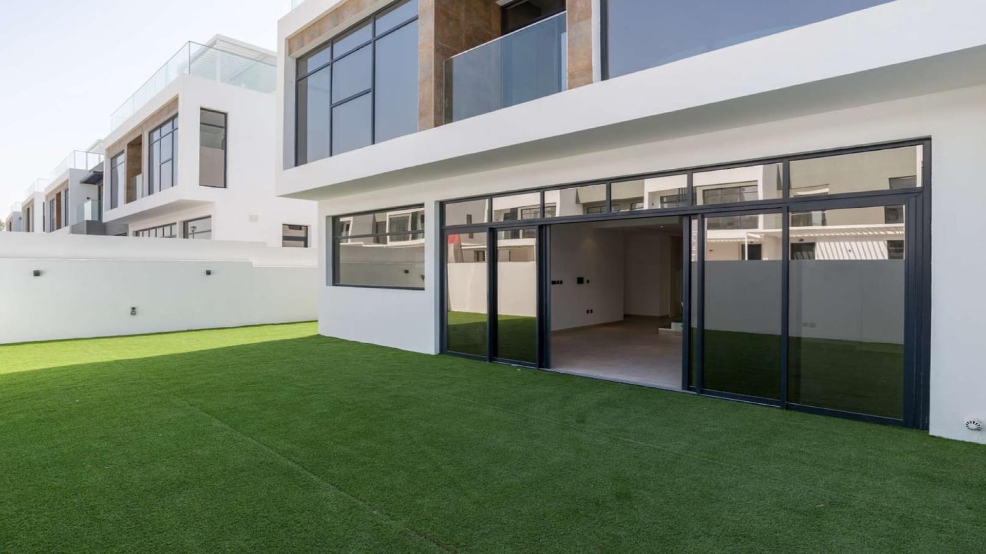 Stunning Flower Villa townhouse exterior, Jumeirah Golf Estates, green lawn, modern architecture