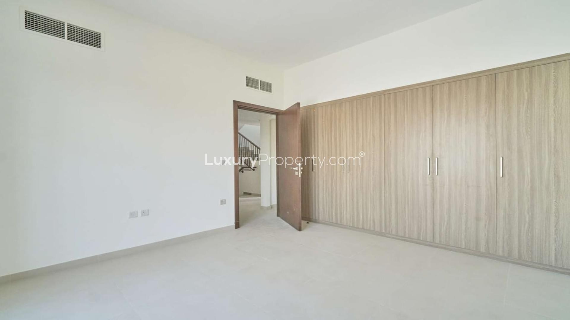 Empty bedroom with built-in wardrobes in Dubai Sports City townhouse for rent