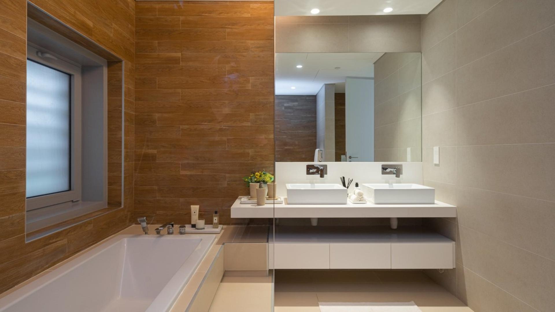 Modern kitchen and living area in Bluewaters townhouse, featuring sleek design and ocean views