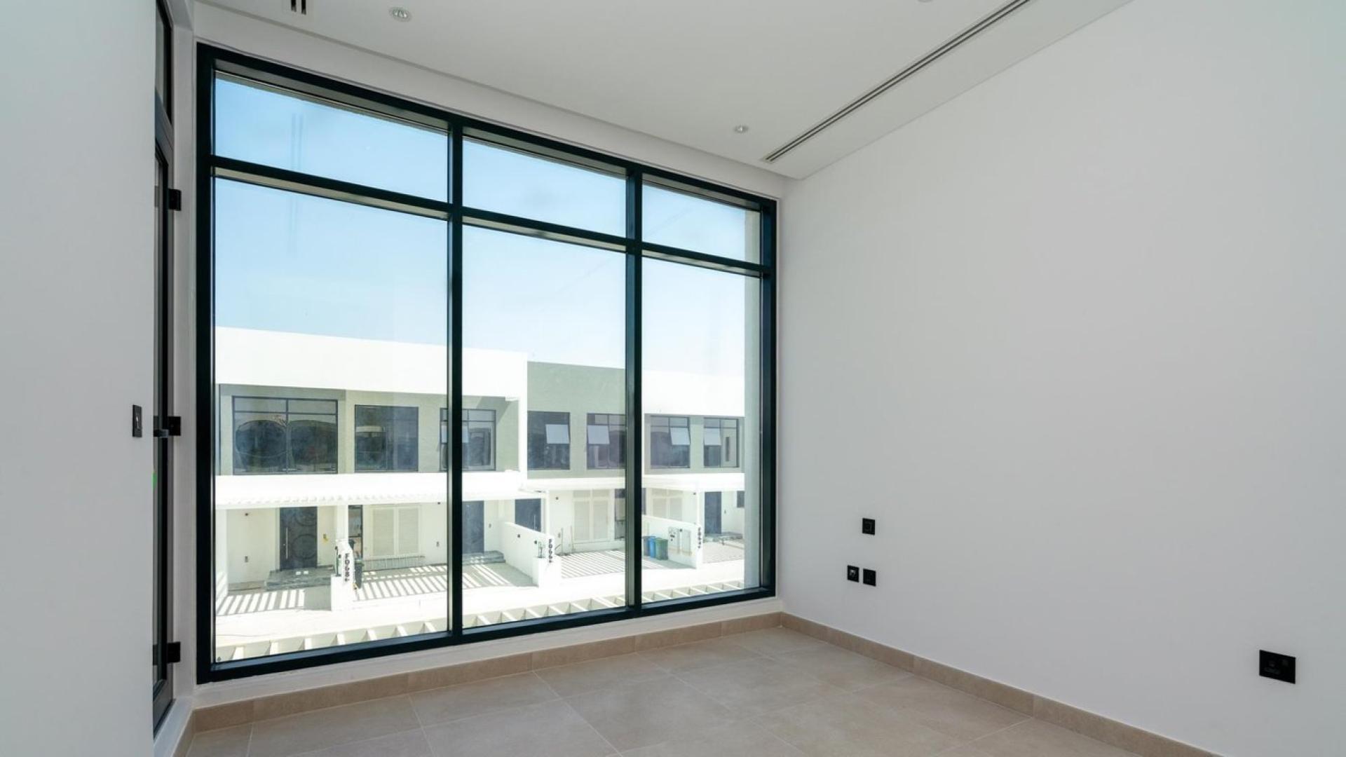 "Spacious townhouse balcony with golf course view in Jumeirah Golf Estates, for sale.","Spacious townhouse interior with large windows in Jumeirah Golf Estates, overlooking luxury homes.",Modern kitchen and staircase in Jumeirah Golf Estates townhouse, LP11792 for sale