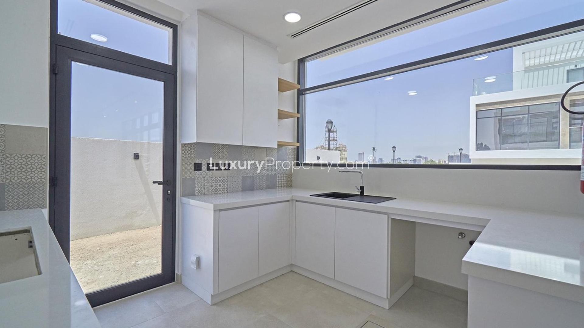 Modern townhouse interior with glass staircase, open layout in Jumeirah Golf Estates, for sale