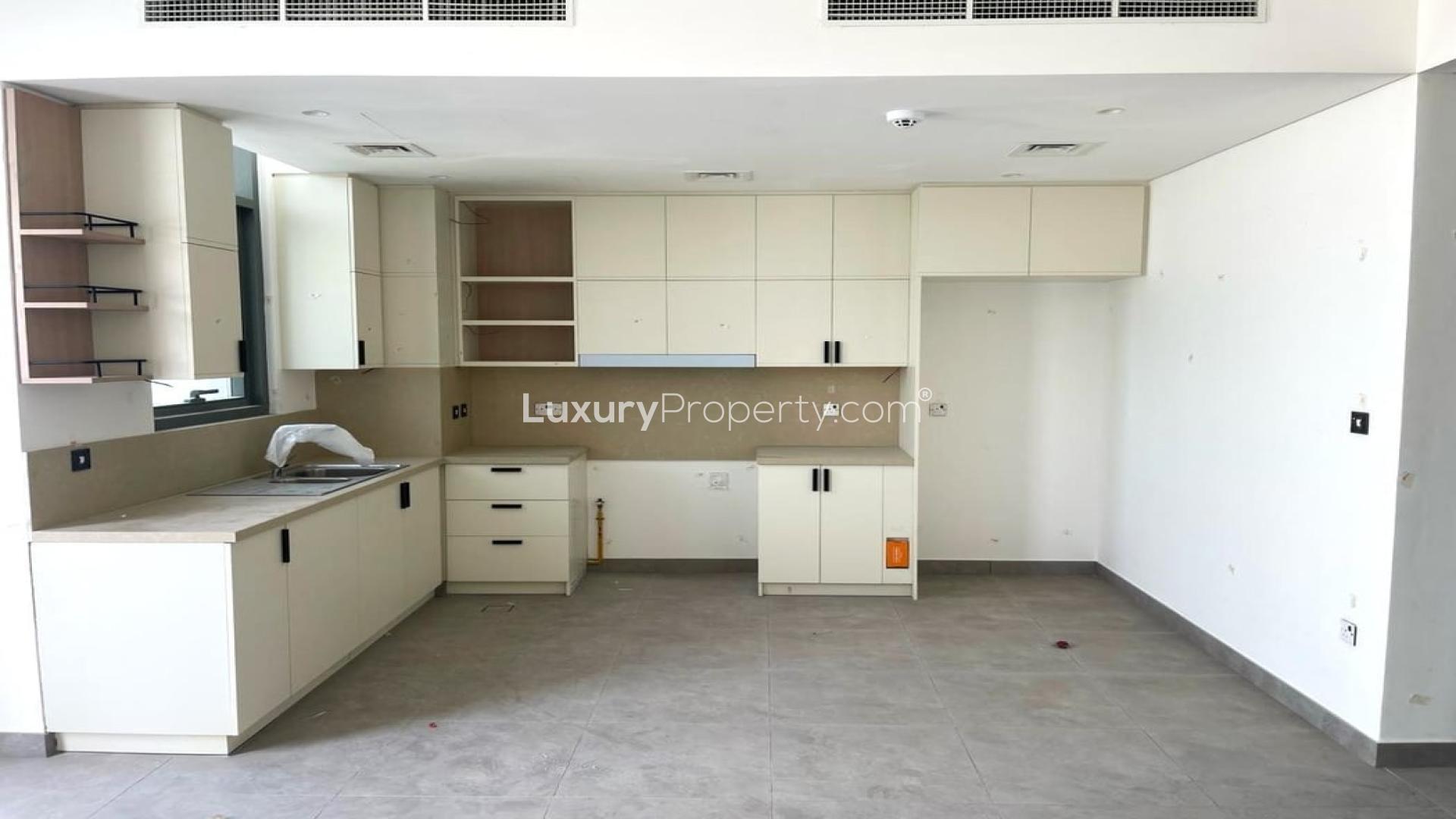 Spacious open-plan kitchen and living area in Ruba townhouse, Arabian Ranches 3