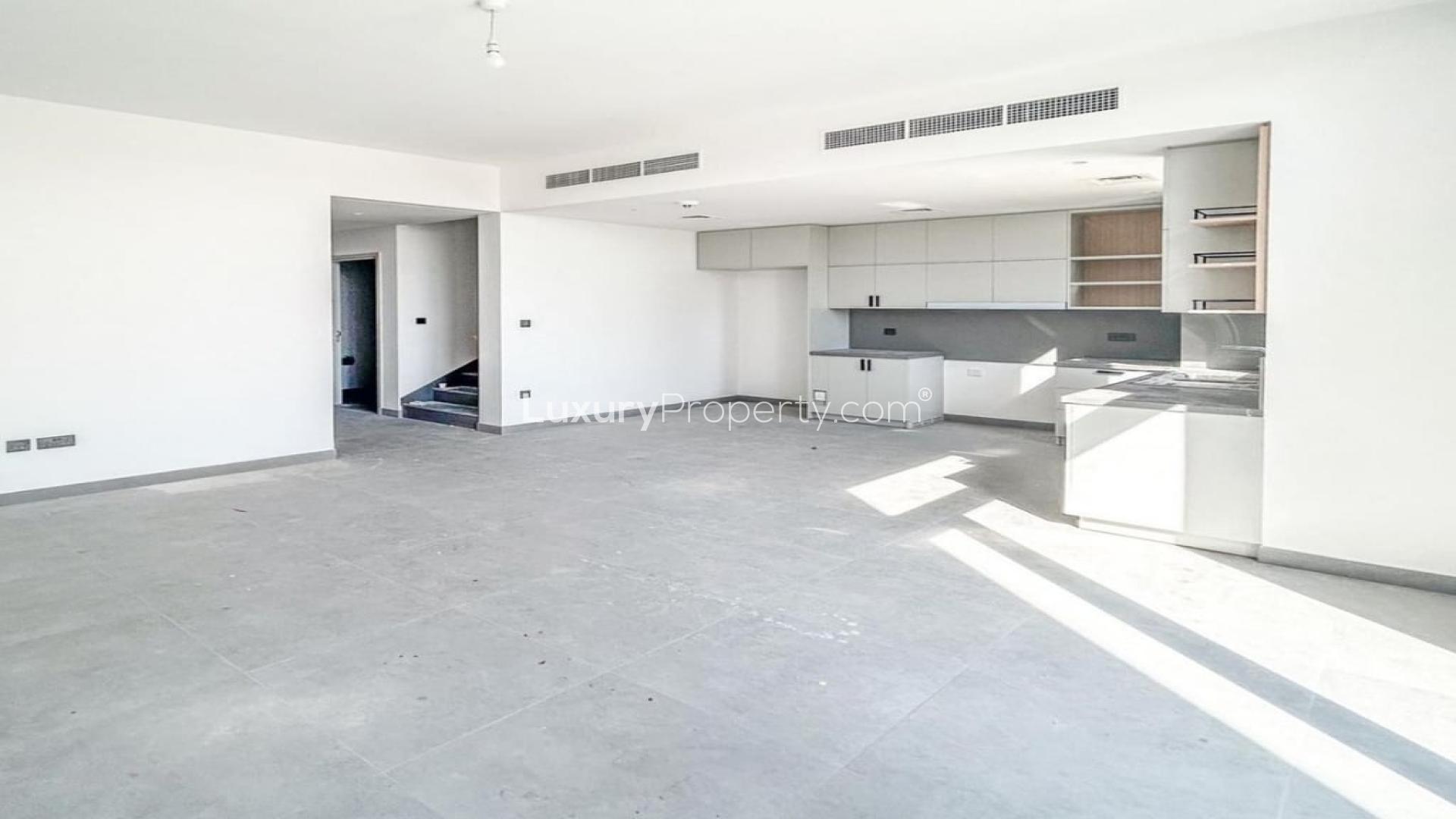 Modern townhouse interior with sleek glass staircase in Arabian Ranches 3, Ruba community