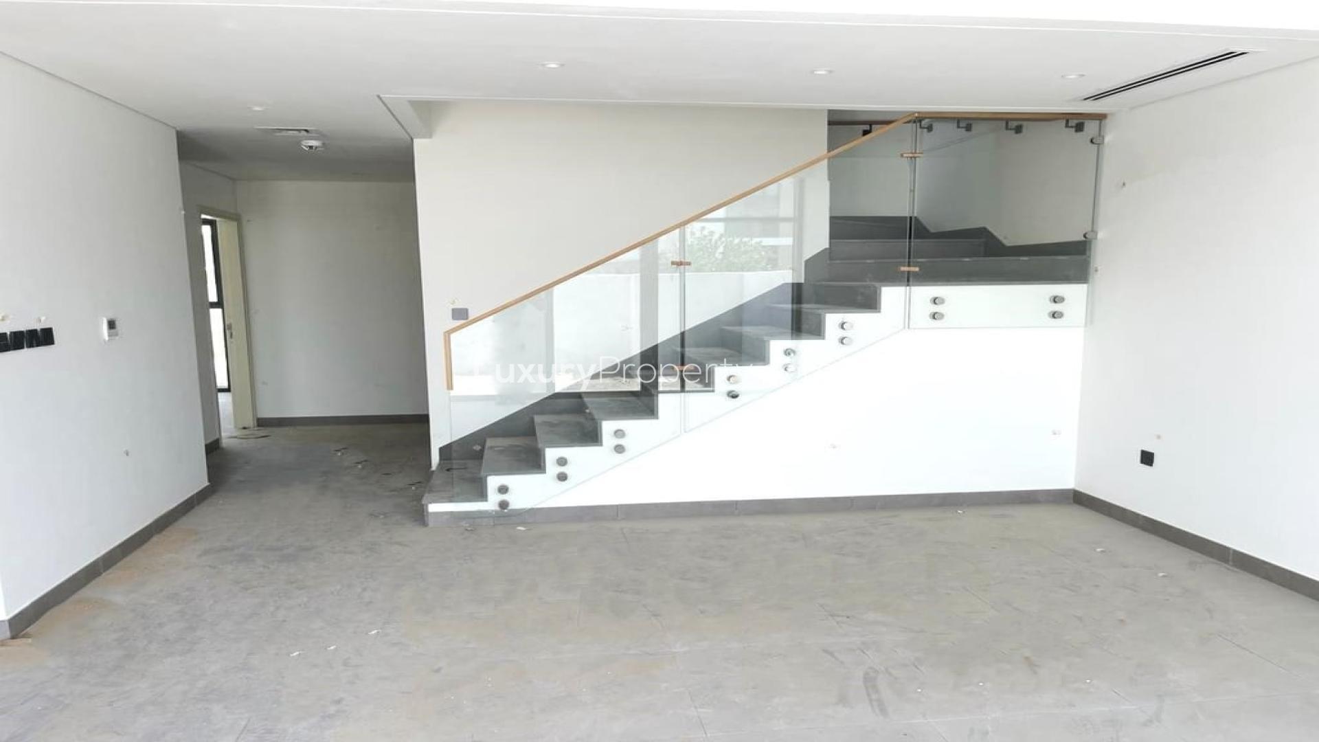 Modern townhouse community path in Arabian Ranches 3, Ruba, featuring landscaped gardens