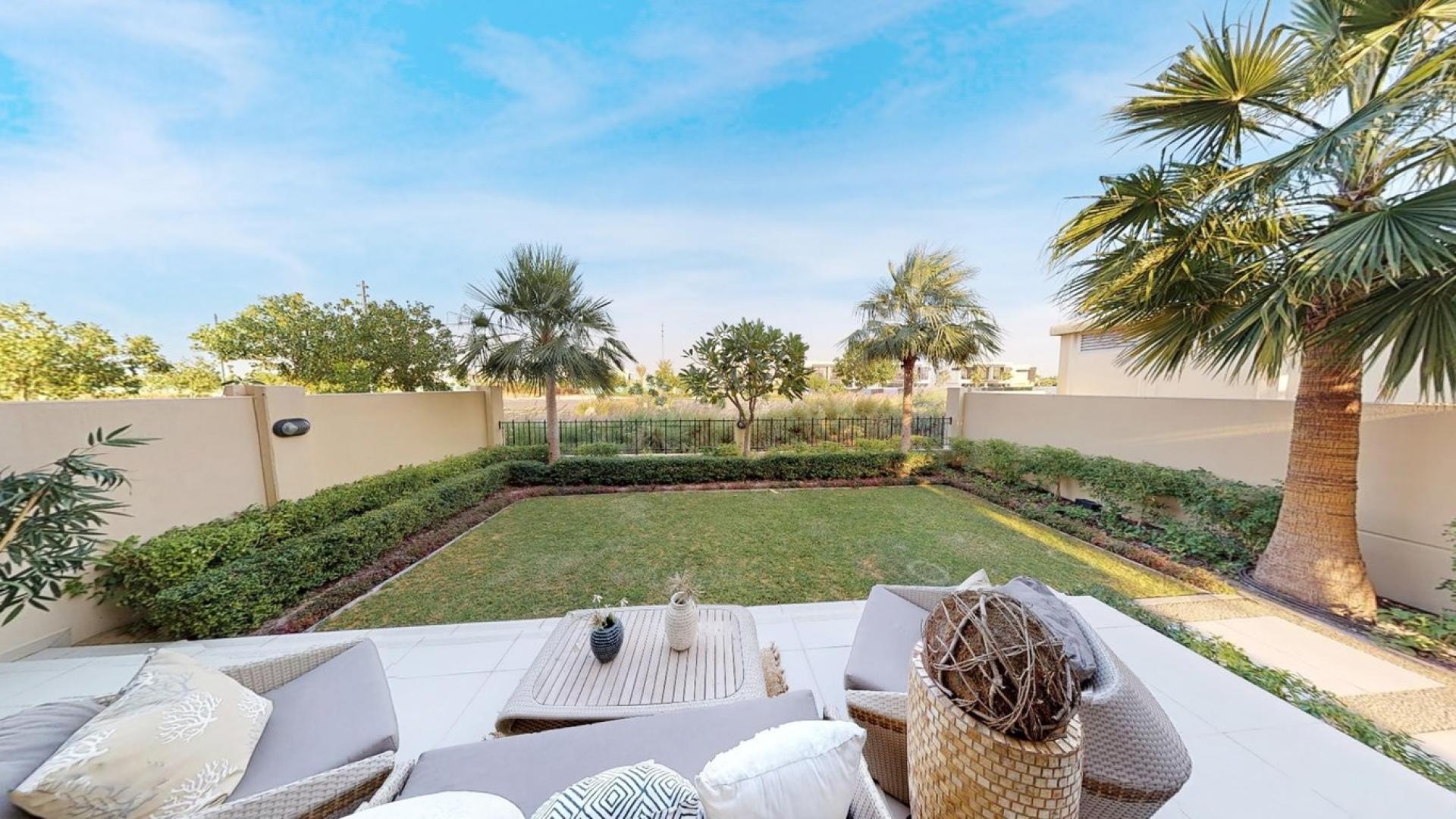 Elegant living room in Damac Hills townhouse, featuring luxurious decor and spacious layout