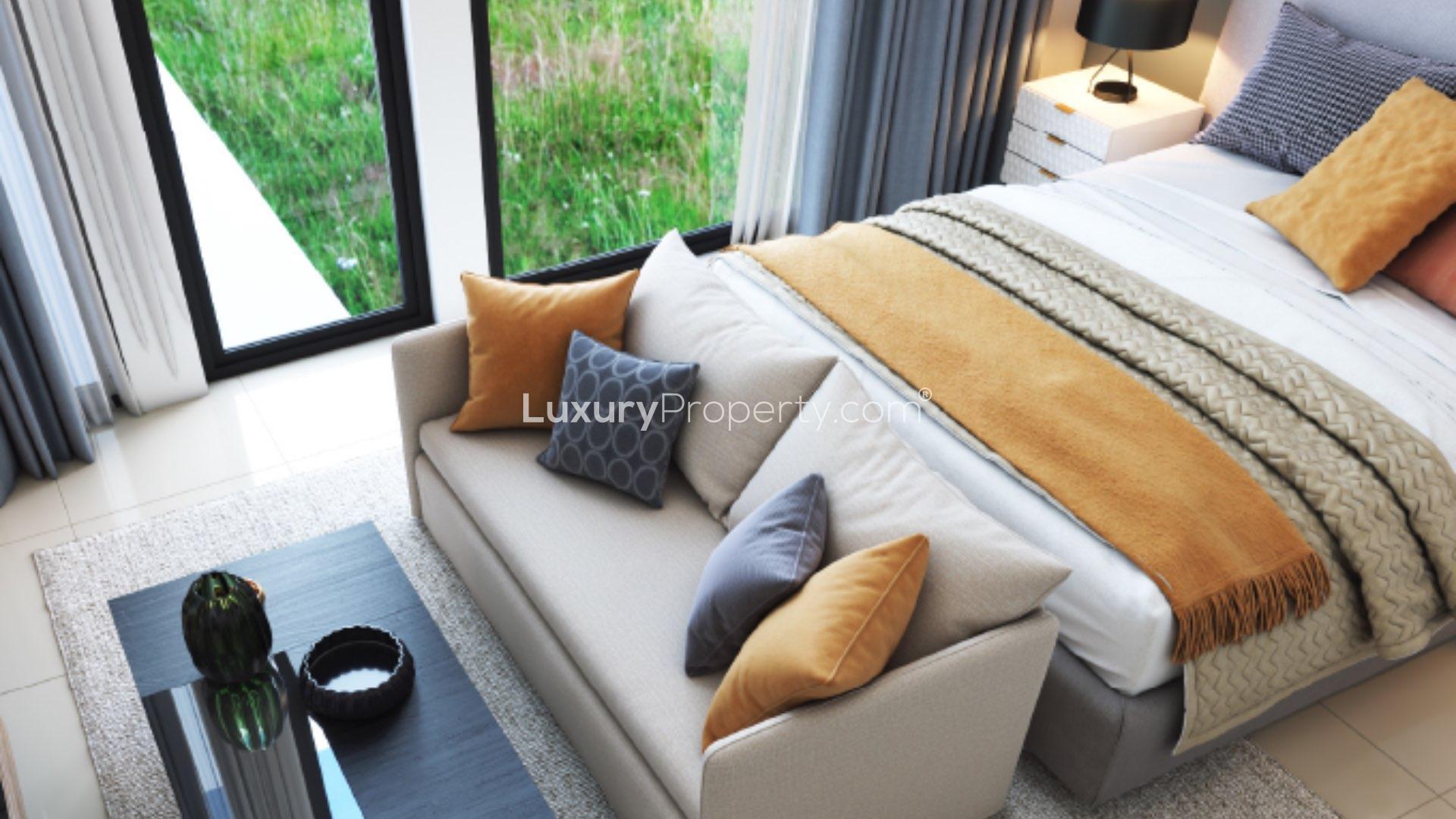 Modern living room in 4-bedroom townhouse, Muscat Hills, with abstract art and cozy seating