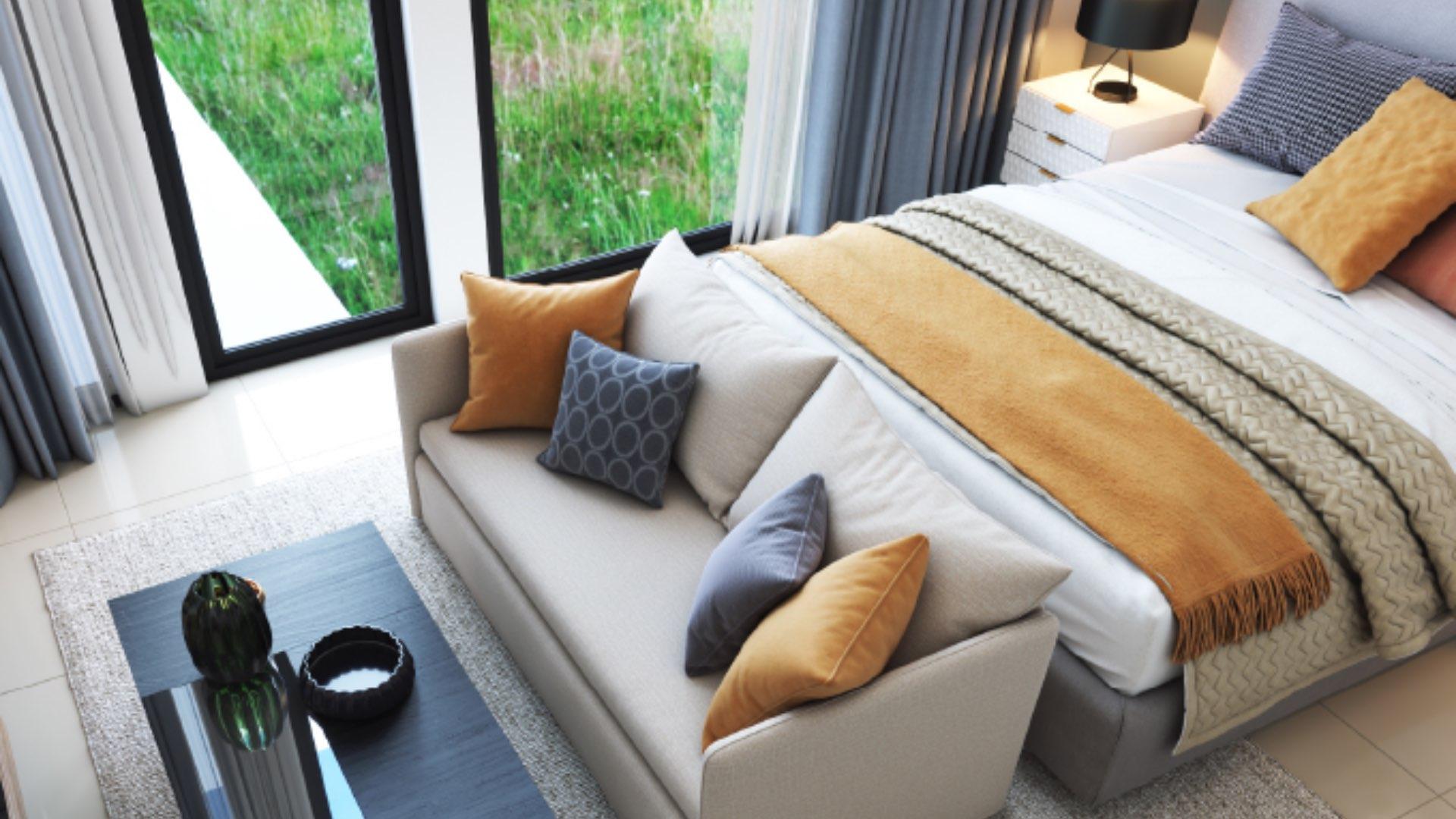 Modern living room in 4-bedroom townhouse, Muscat Hills, with abstract art and cozy seating