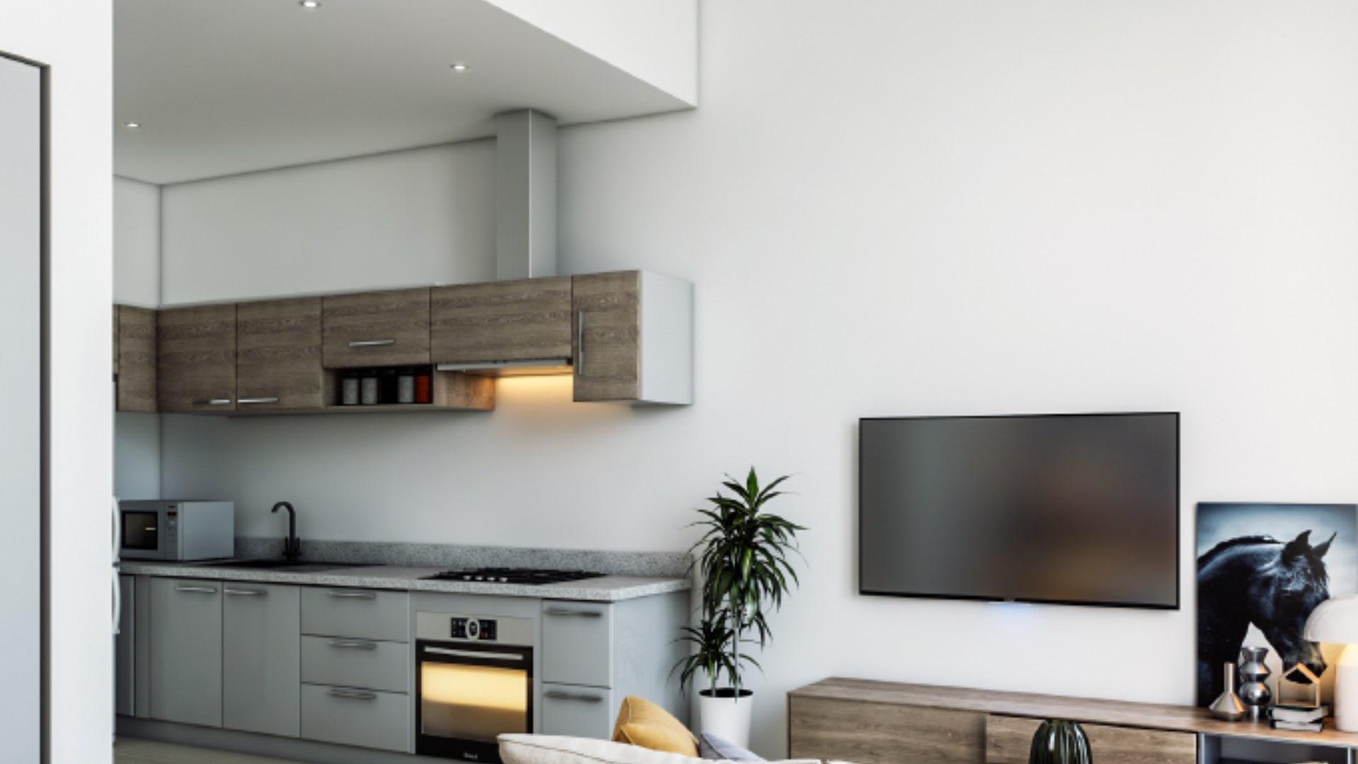 Modern bedroom with cozy sofa, vibrant pillows, and garden view at Muscat Hills townhouse