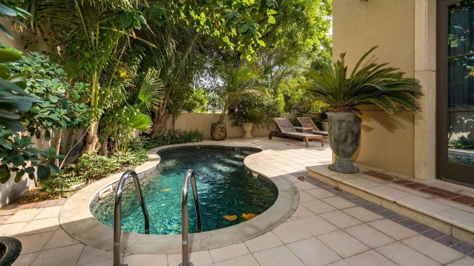 Private pool area of furnished villa in Jumeirah Golf Estates' Earth community