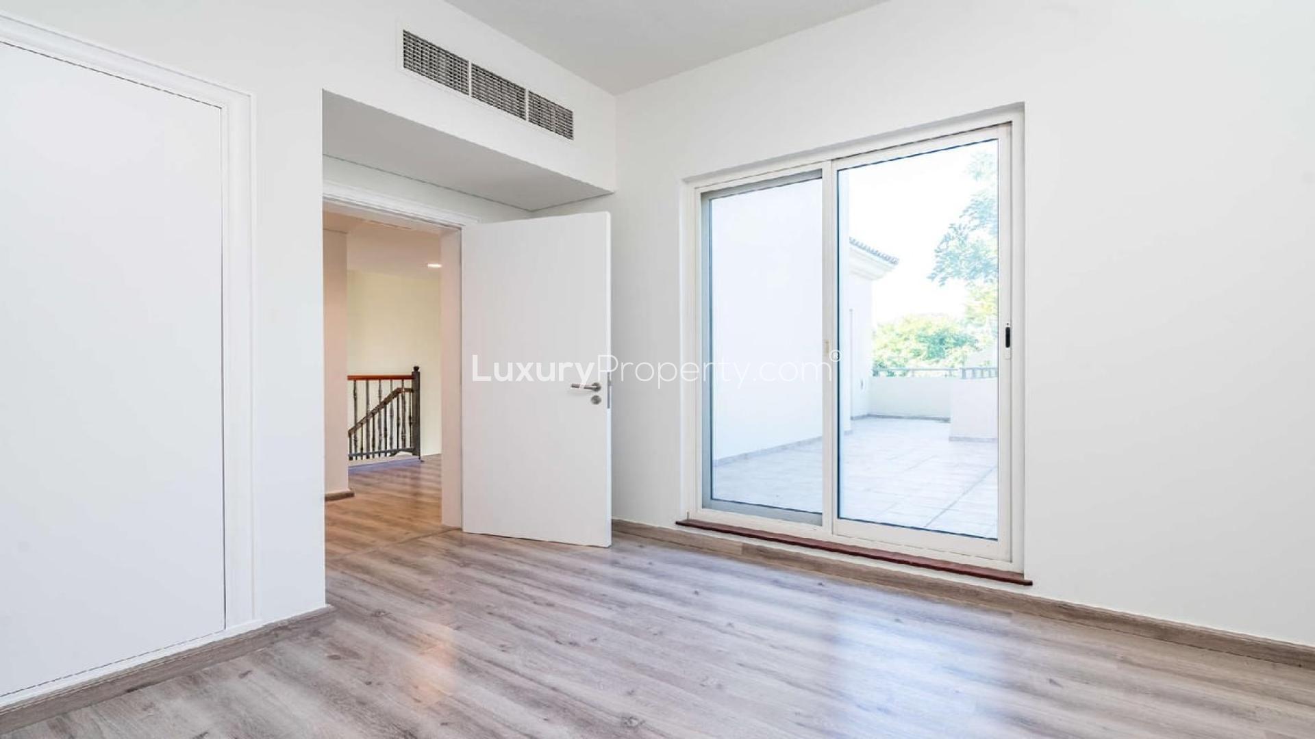 Bright room with sliding glass doors, garden view in Victory Heights villa, Dubai Sports City