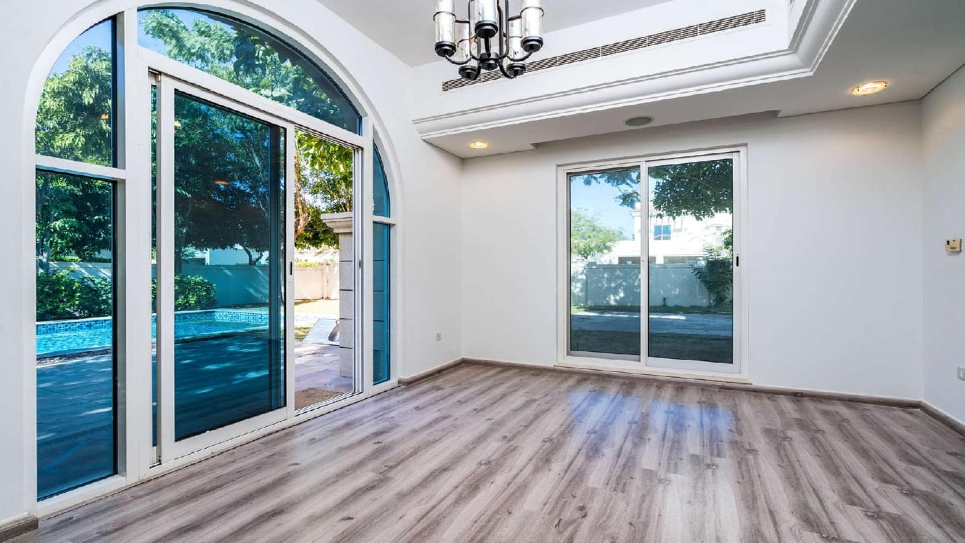 Serene 4-bedroom villa exterior with lush greenery in Victory Heights, Dubai Sports City