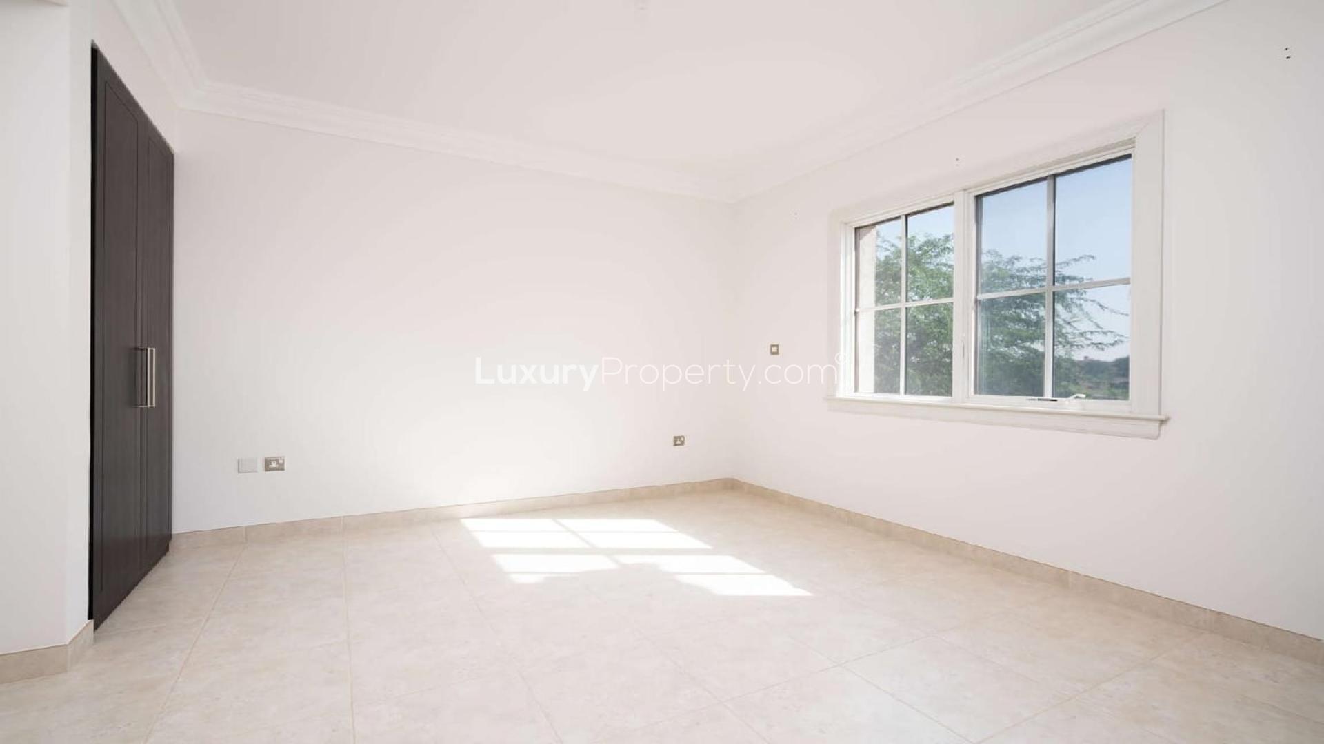 Elegant 4-bedroom villa exterior with garage in Whispering Pines, Jumeirah Golf Estates