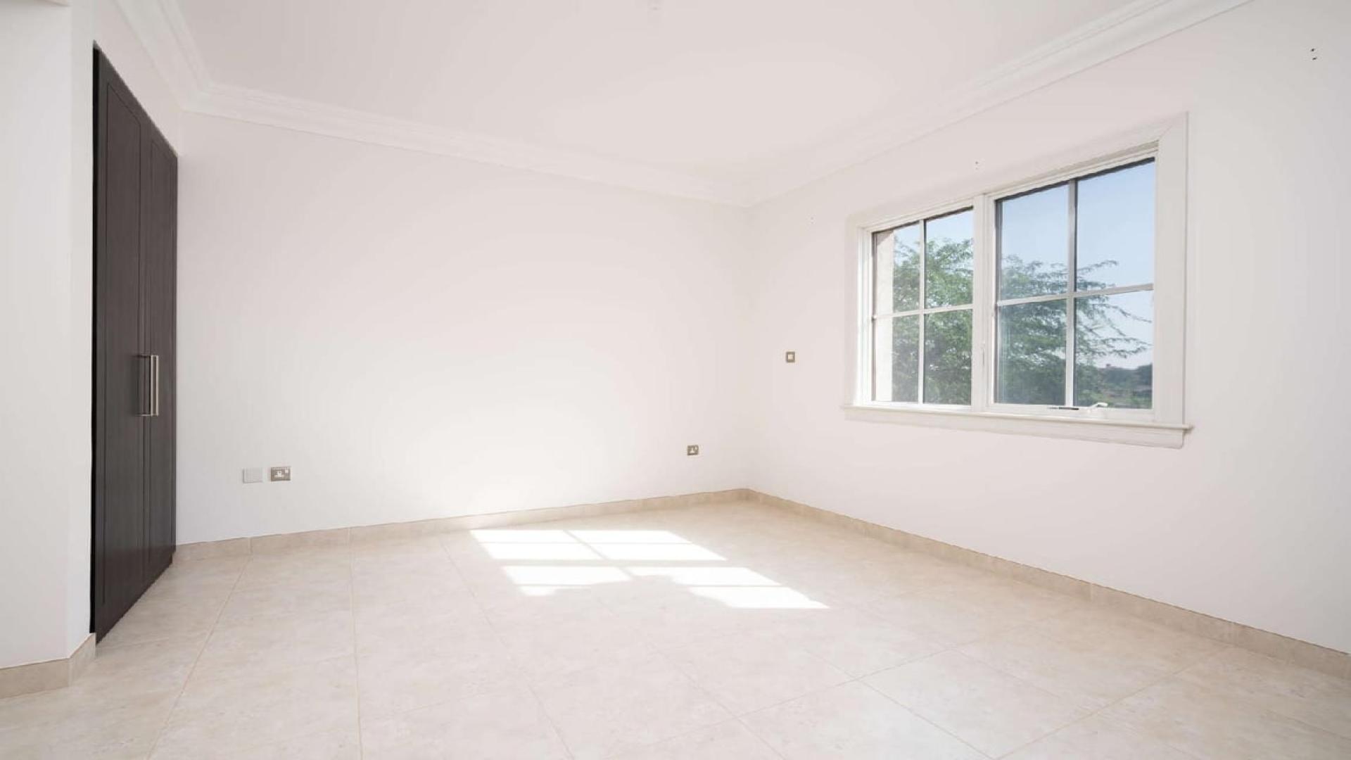 Elegant 4-bedroom villa exterior with garage in Whispering Pines, Jumeirah Golf Estates