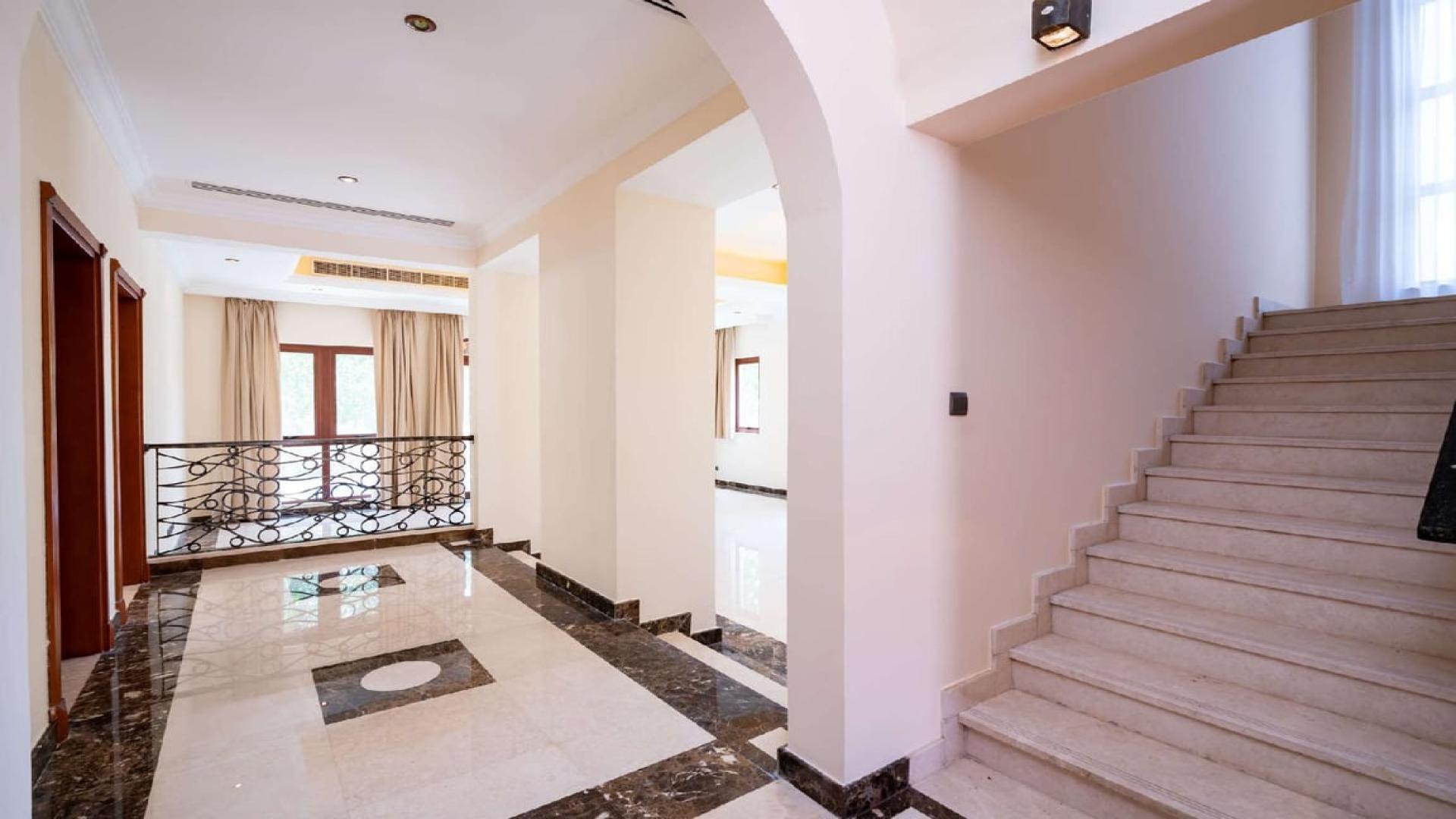 Spacious modern kitchen in 4-bedroom villa, Orange Lake, Jumeirah Golf Estates, with wooden cabinets