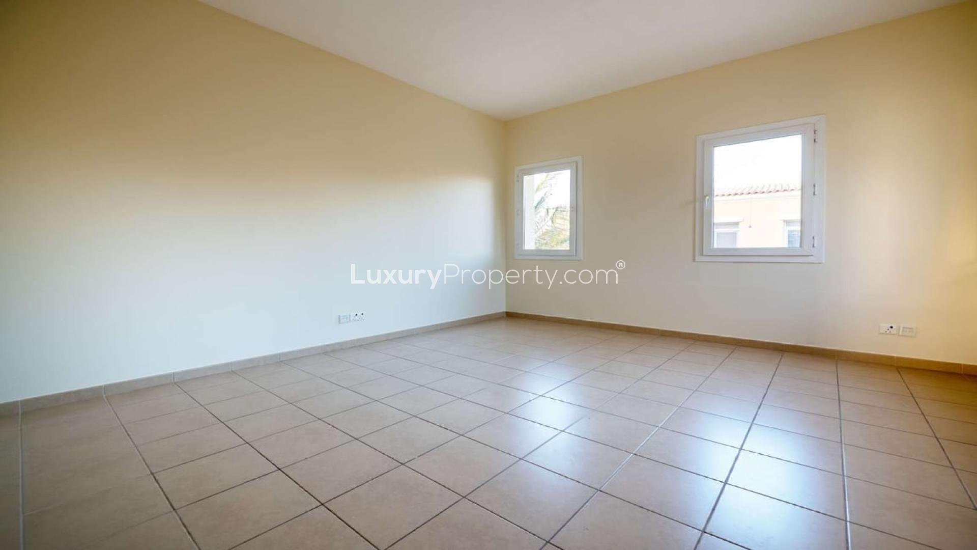 Spacious living room in 4-bedroom villa, Palmera 4, Arabian Ranches, with large windows and patio